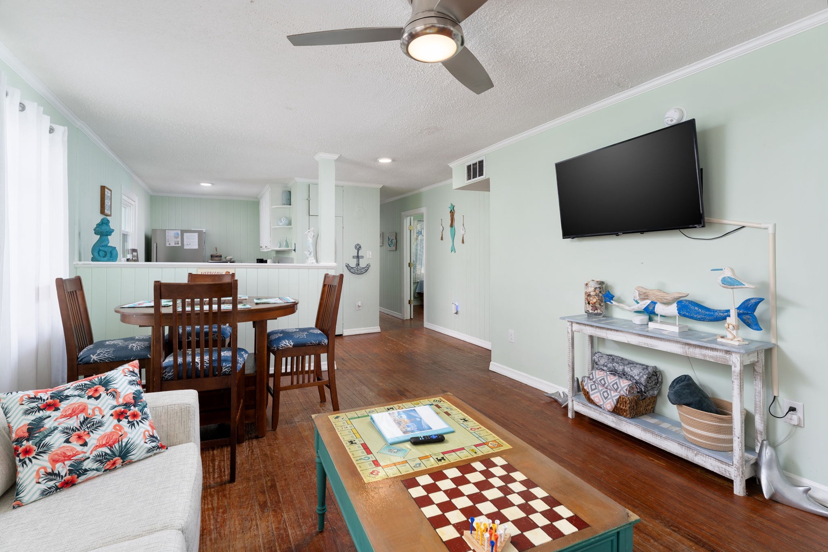 Relax in your cheerful coastal living space with dining area, games, and nautical charm throughout.