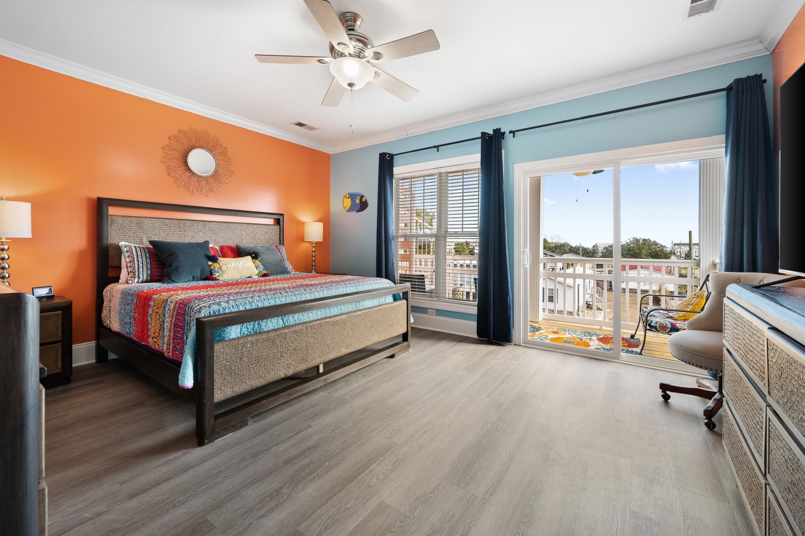 Wake up to colorful comfort in your vibrant bedroom, where cheerful orange walls and cozy bedding create the perfect retreat for restful nights.
