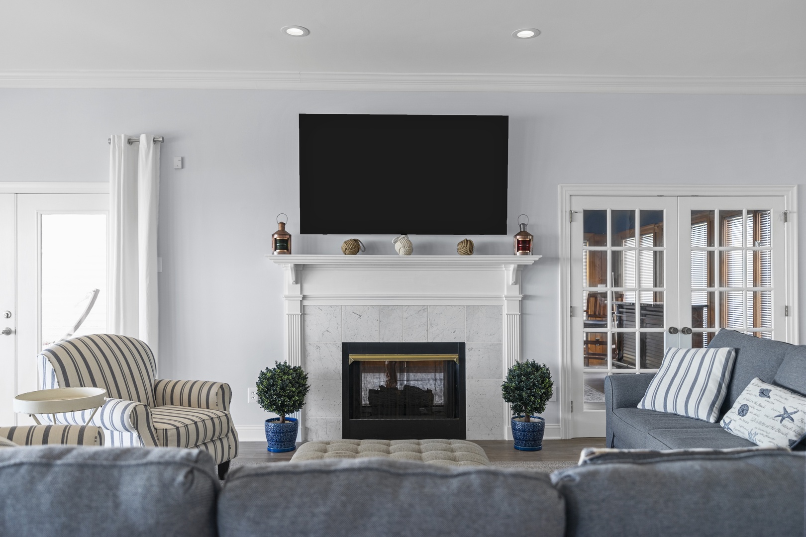 Cozy up in your elegant living room with plush seating, a warm fireplace, and entertainment center for perfect evenings in.