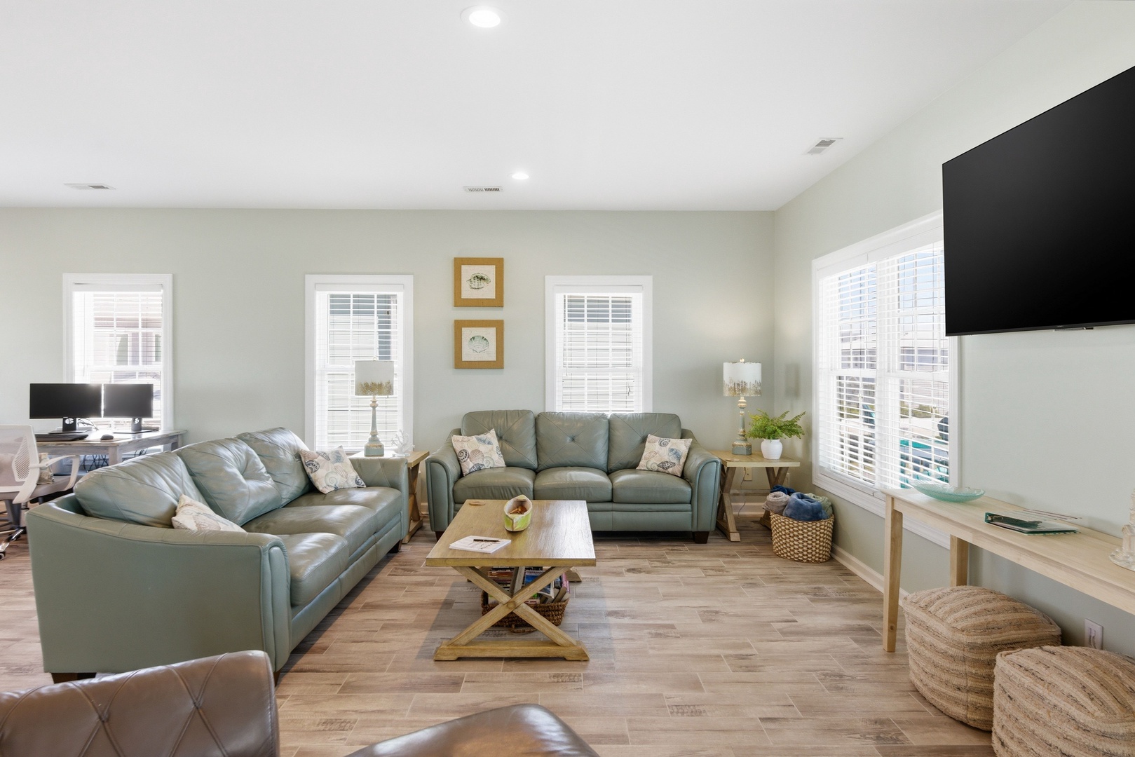 Settle in and relax on plush seating with abundant natural light, modern entertainment, and coastal accents creating your inviting home base for getaway memories.