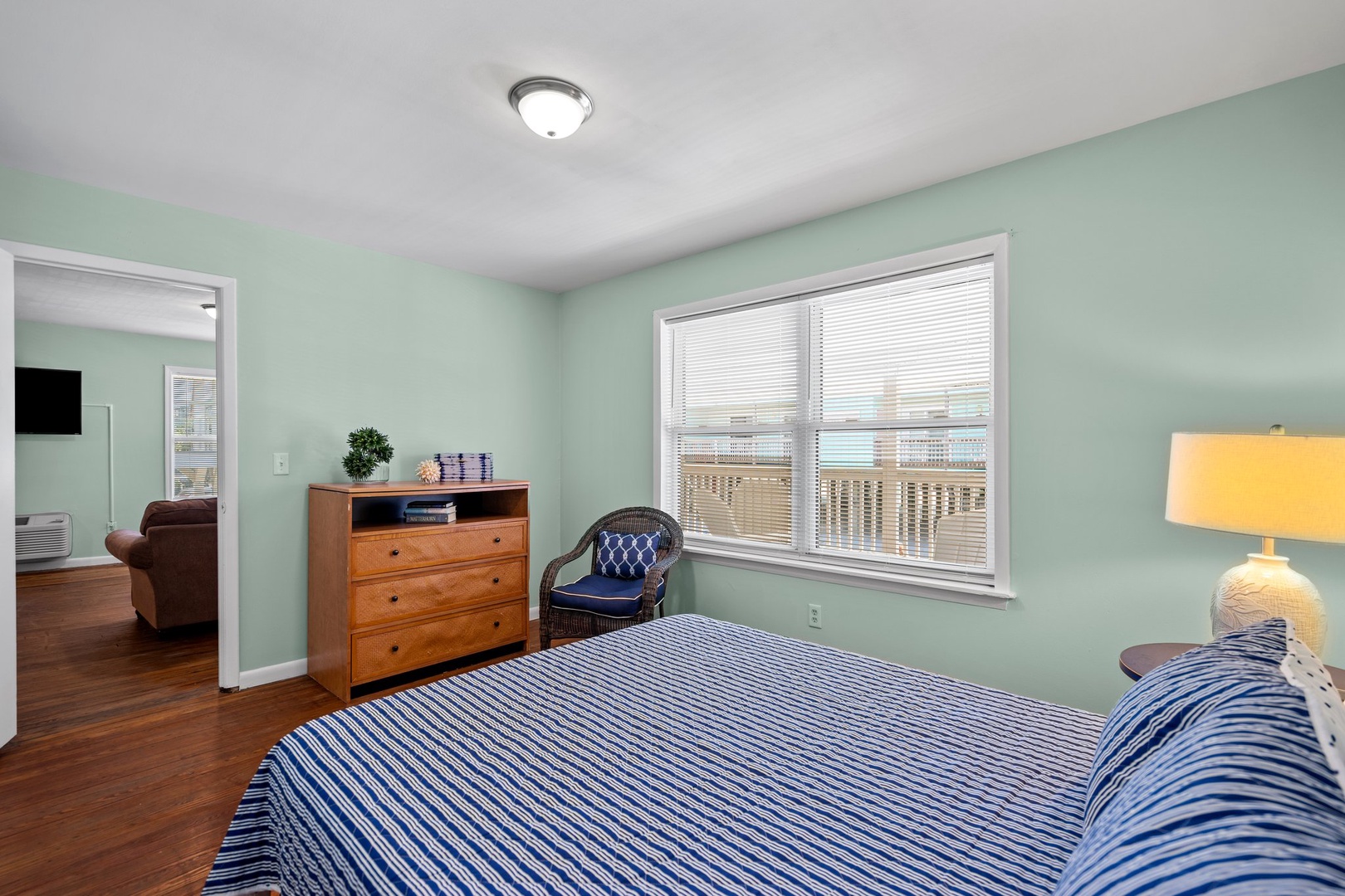 Relax in your serene bedroom with soothing mint walls and enjoy stunning city views through oversized windows.
