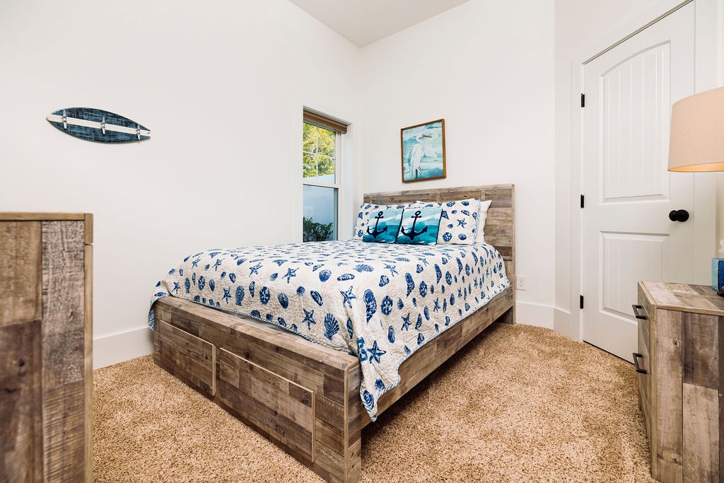 Drift off to sleep in your coastal-themed bedroom, where nautical touches and rustic wood create the perfect seaside sanctuary for peaceful nights.