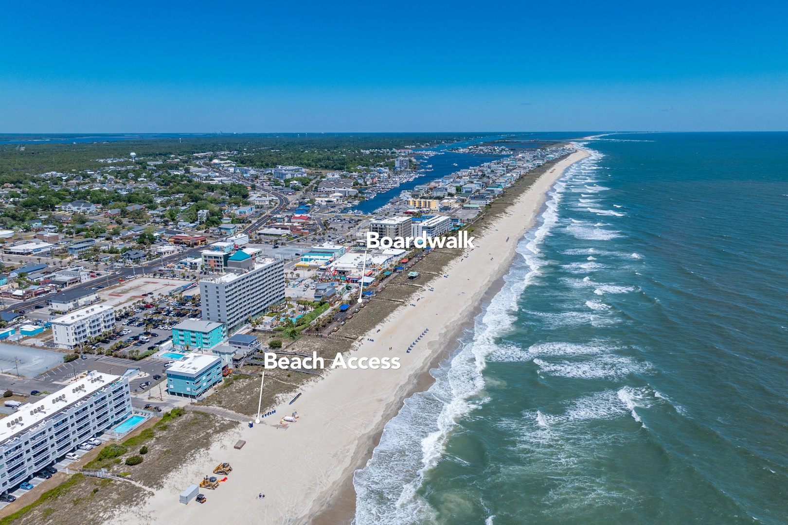 Stunning aerial view of the oceanfront community featuring pristine beaches, boardwalk entertainment, and easy beach access.
