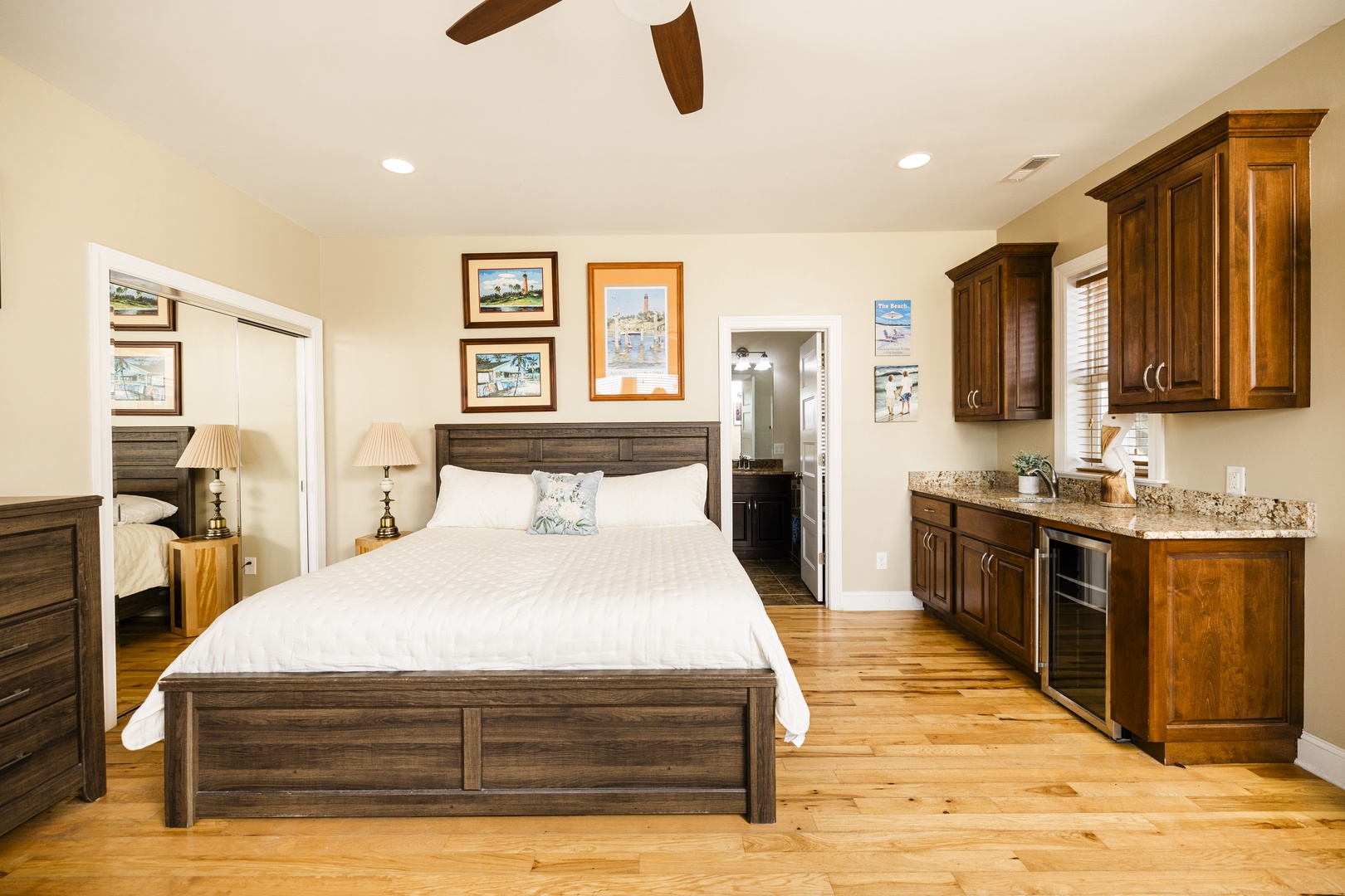 Relax in your spacious bedroom suite with rich wood furnishings, granite counters, and warm hardwood floors beneath exposed beams.