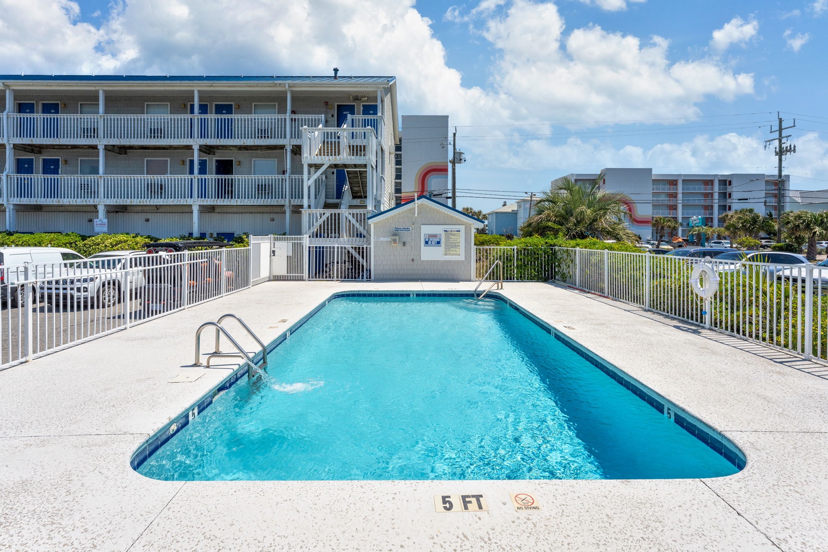 Dive into crystal-clear waters at your private pool oasis, surrounded by tropical palms and sunny Florida skies for the perfect vacation escape.