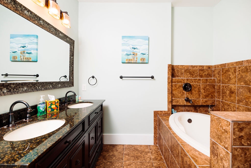 Unwind in your spacious bathroom with dual vanities and a luxurious corner soaking tub perfect for relaxing after exploring.