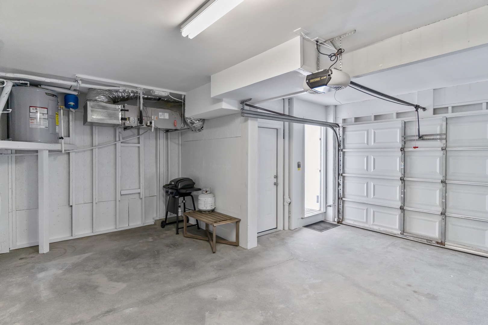 Spacious garage with convenient storage, BBQ grill, and utility systems - your perfect base for gear and outdoor adventures.