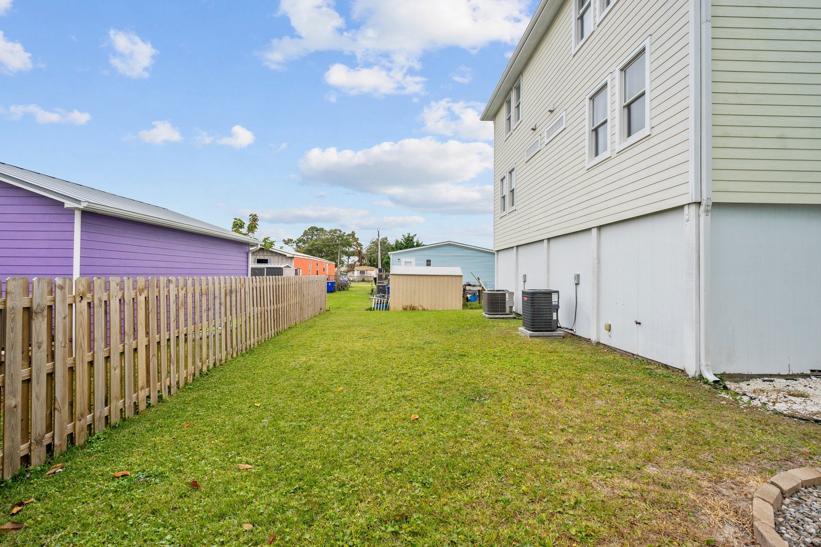 Spacious private backyard with fresh green lawn, perfect for outdoor relaxation and family activities in a quiet residential neighborhood.