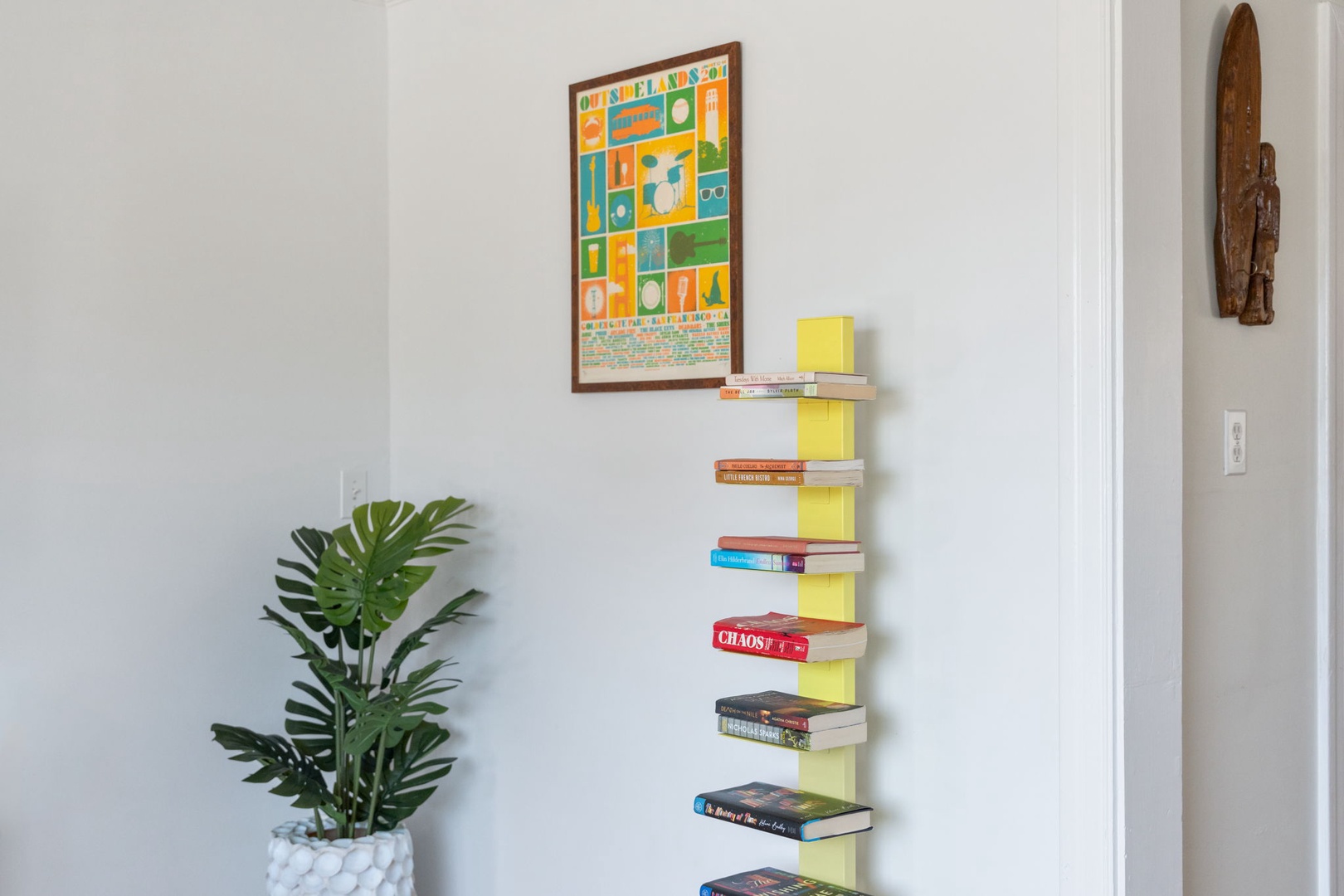 Relax with your favorite book from the thoughtfully curated library, featuring a unique floating shelf design and artistic touches.