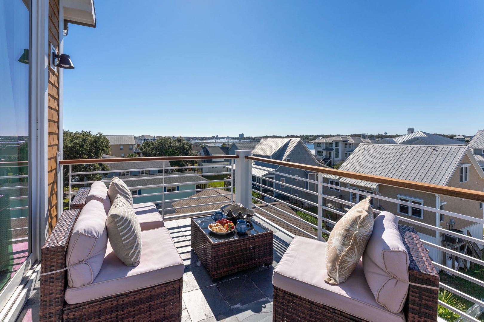 Sink into plush outdoor cushions on your private balcony, where morning coffee and evening sunset views create perfect moments above the cityscape.