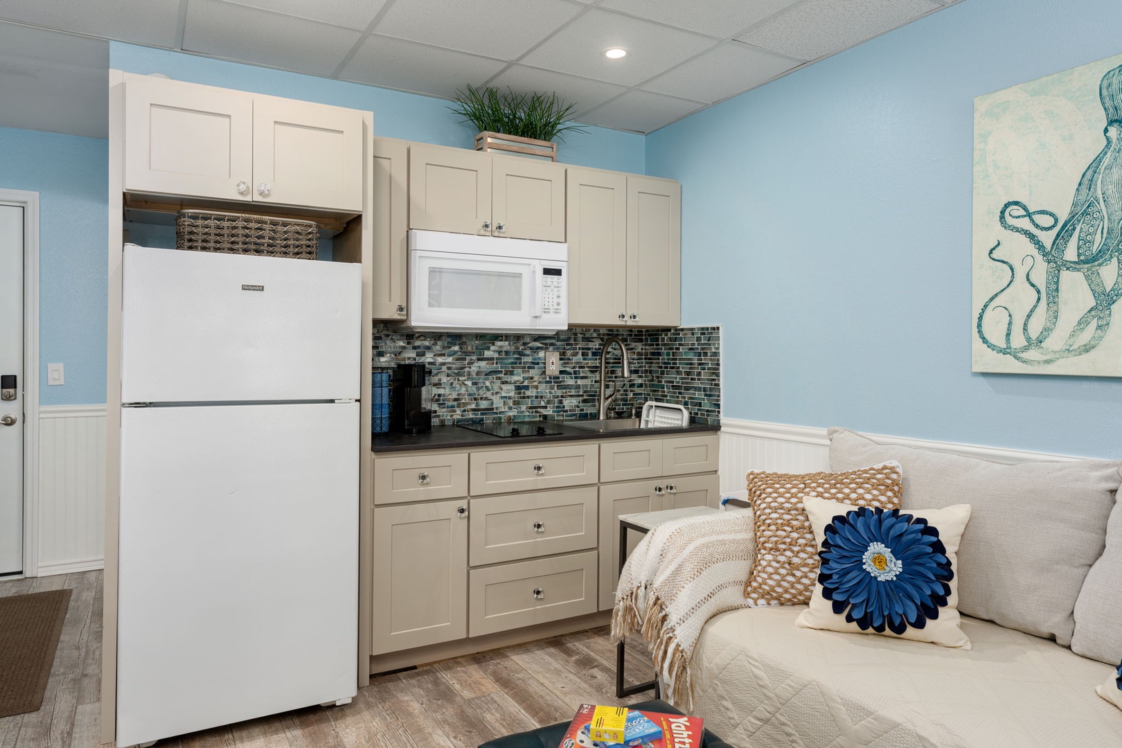 Your spacious kitchen features full-size appliances, soothing coastal colors, and a cozy living area perfect for preparing meals and relaxing.