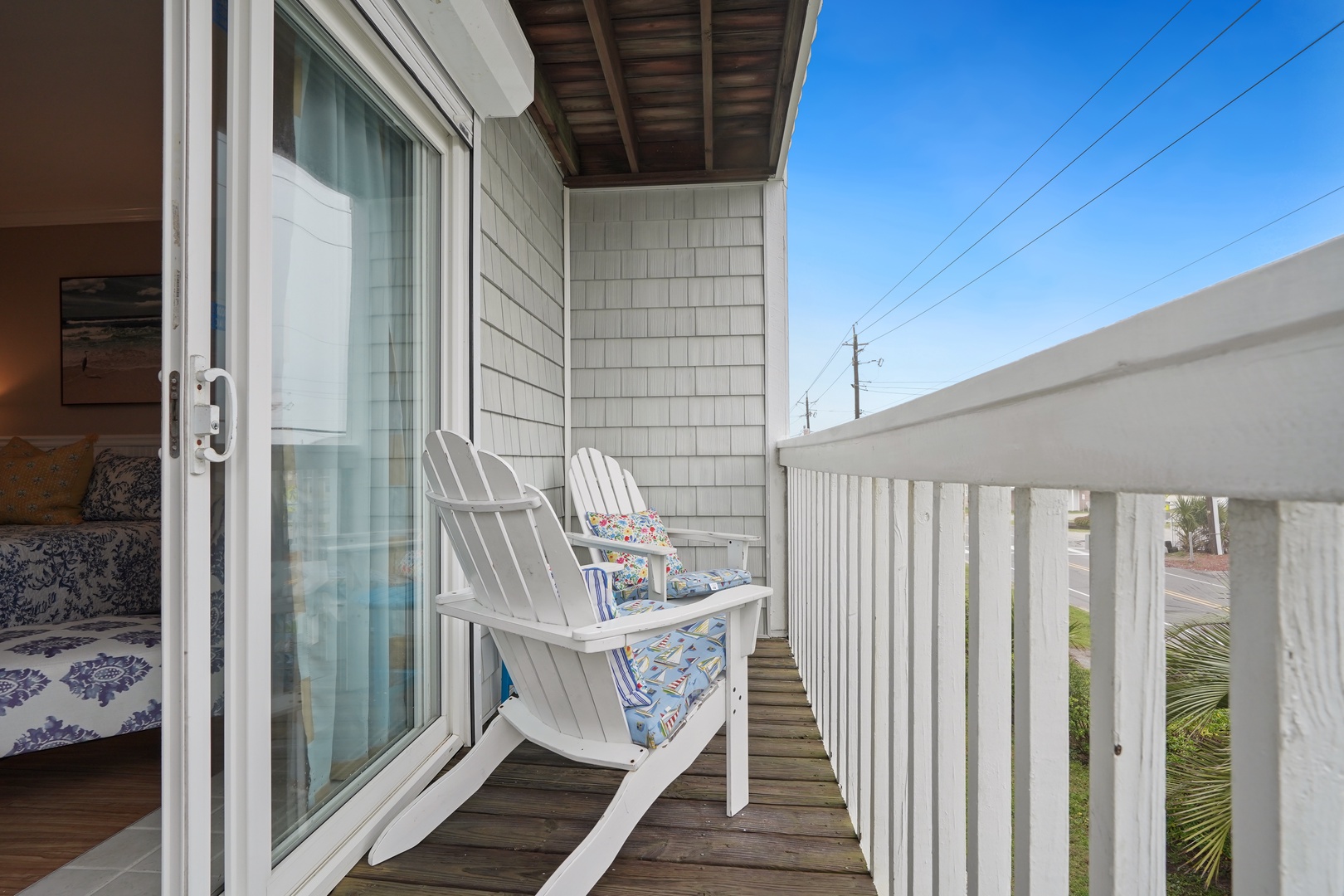 Step onto your private balcony and sink into comfortable Adirondack chairs with cheerful cushions, perfect for morning coffee or evening relaxation.