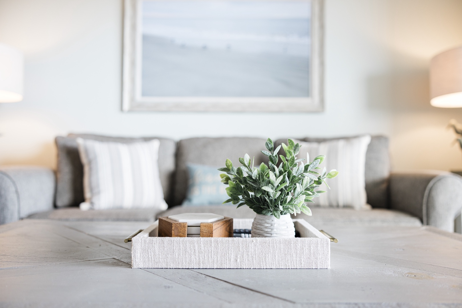 Sink into plush seating with thoughtful touches like fresh greenery creating your perfect retreat for morning coffee or evening relaxation.