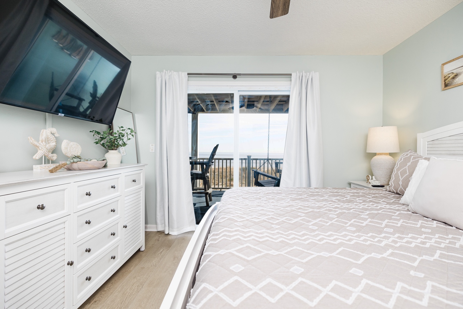 Wake up to serene coastal views from your private balcony. This peaceful bedroom combines comfort with stunning scenery for the perfect getaway.