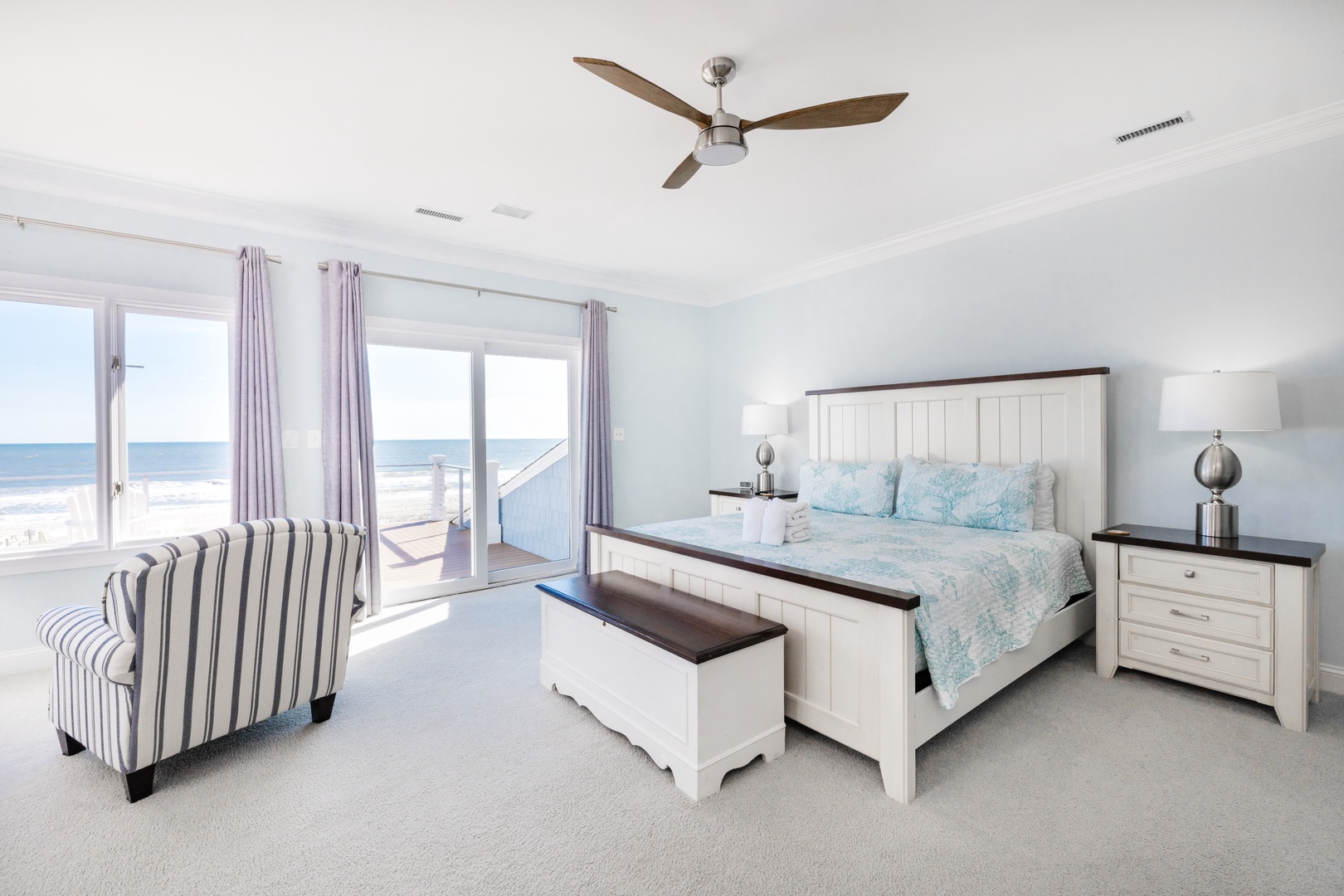 Wake up to stunning ocean views through your private balcony doors. Coastal-inspired decor and soft linens create the perfect seaside retreat.