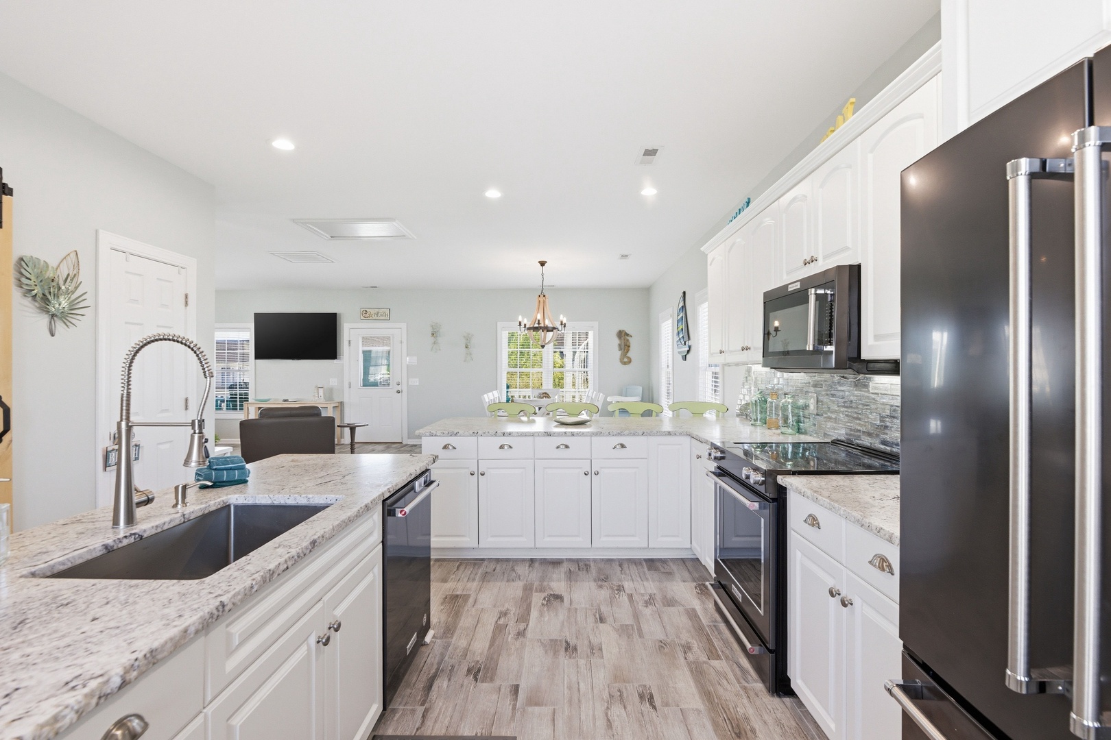 Step into your bright, spacious kitchen where gleaming granite counters, stainless steel appliances, and open island await your culinary adventures. Natural light fills the open-concept space, perfect for gatherings.