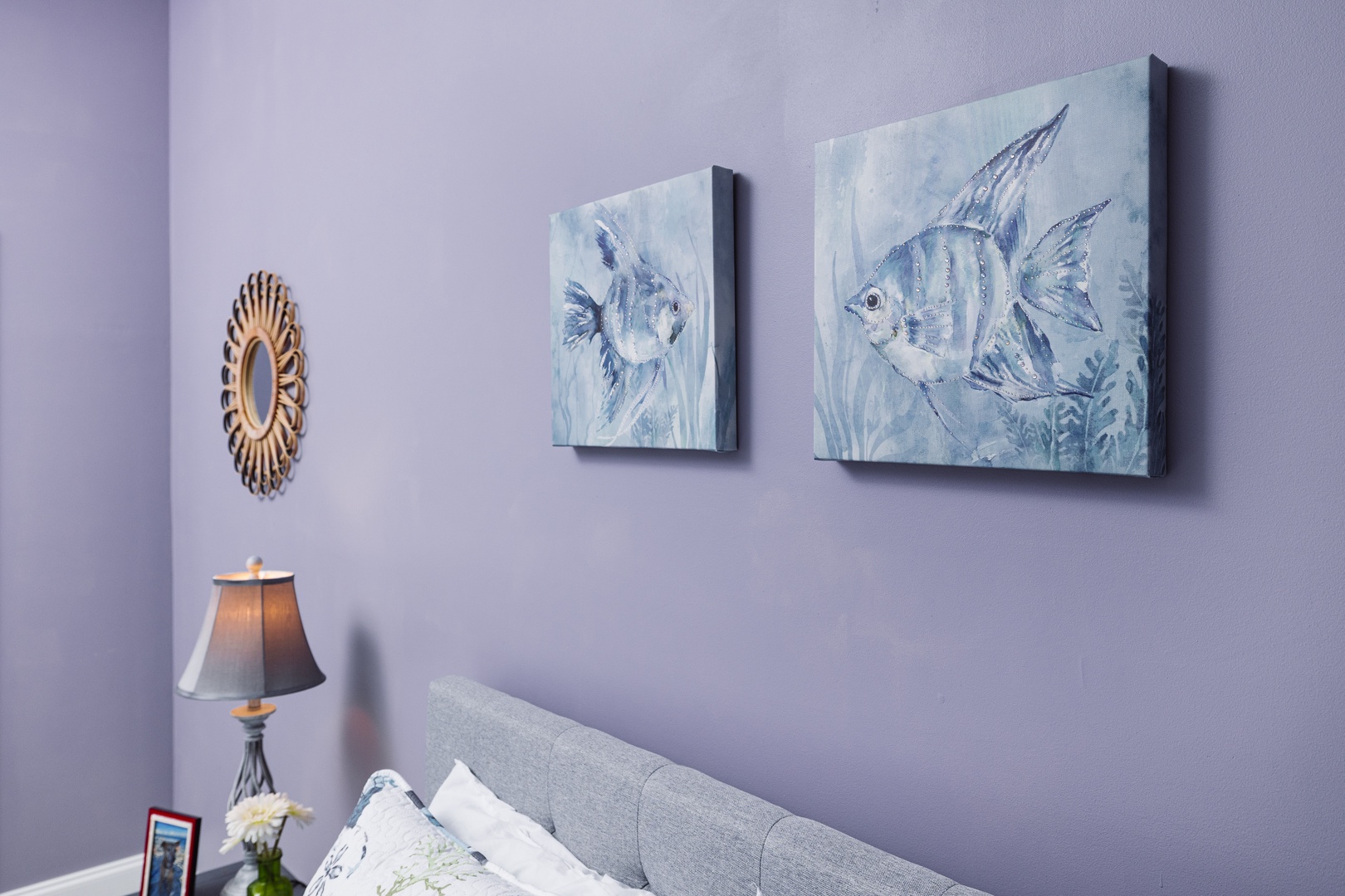 Drift off peacefully beneath soothing ocean-themed artwork and soft lighting in your serene bedroom retreat.