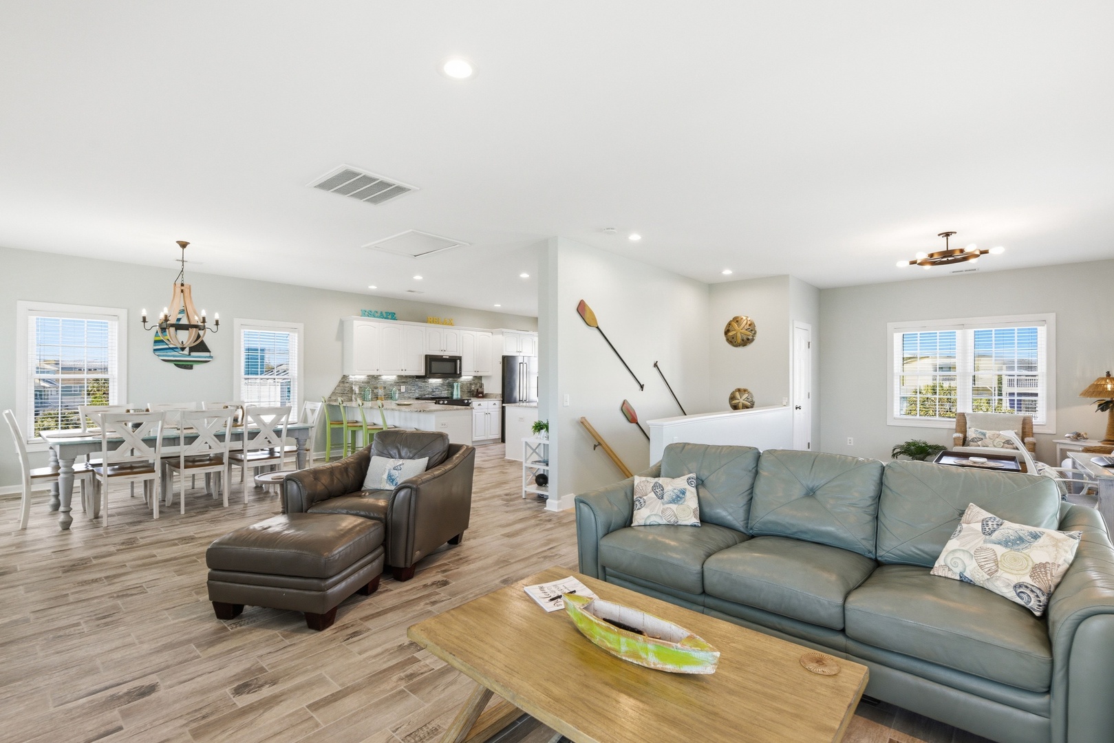 Relax in your coastal-inspired living space where soft ocean hues meet comfort. Sunlight fills the open layout connecting your kitchen, dining, and lounge—perfect for gathering and unwinding after beach adventures.