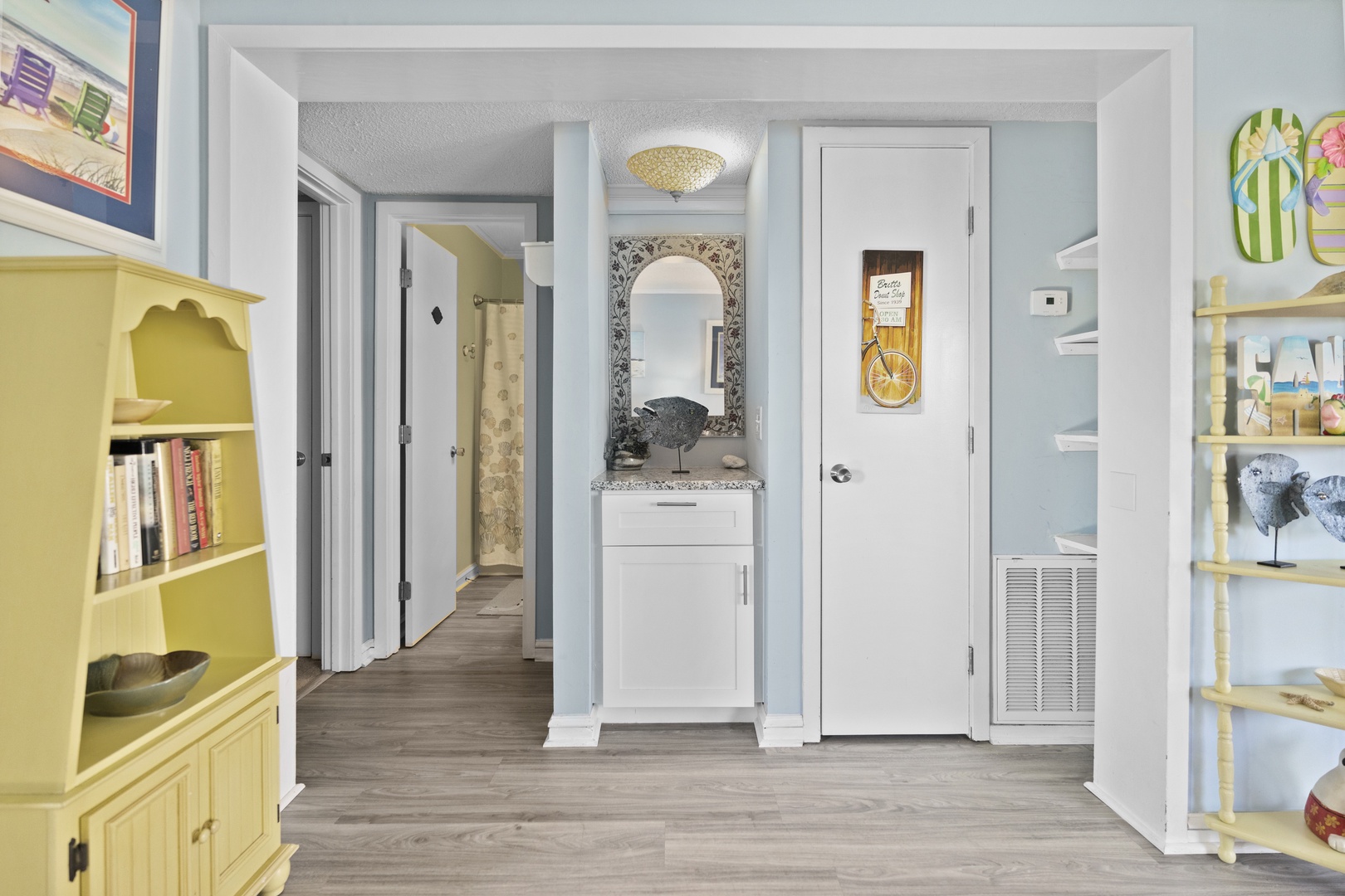 Step into your charming coastal retreat with cheerful yellow built-ins and thoughtful touches throughout this bright, welcoming space.