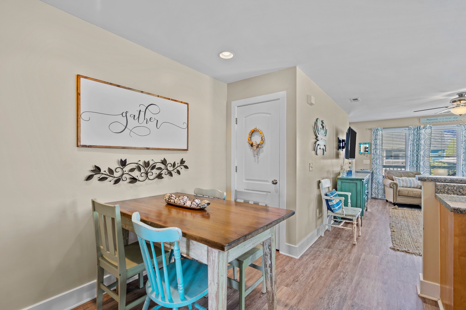 Gather around your charming dining table with rustic wood top and cheerful blue chairs, where memorable meals await.