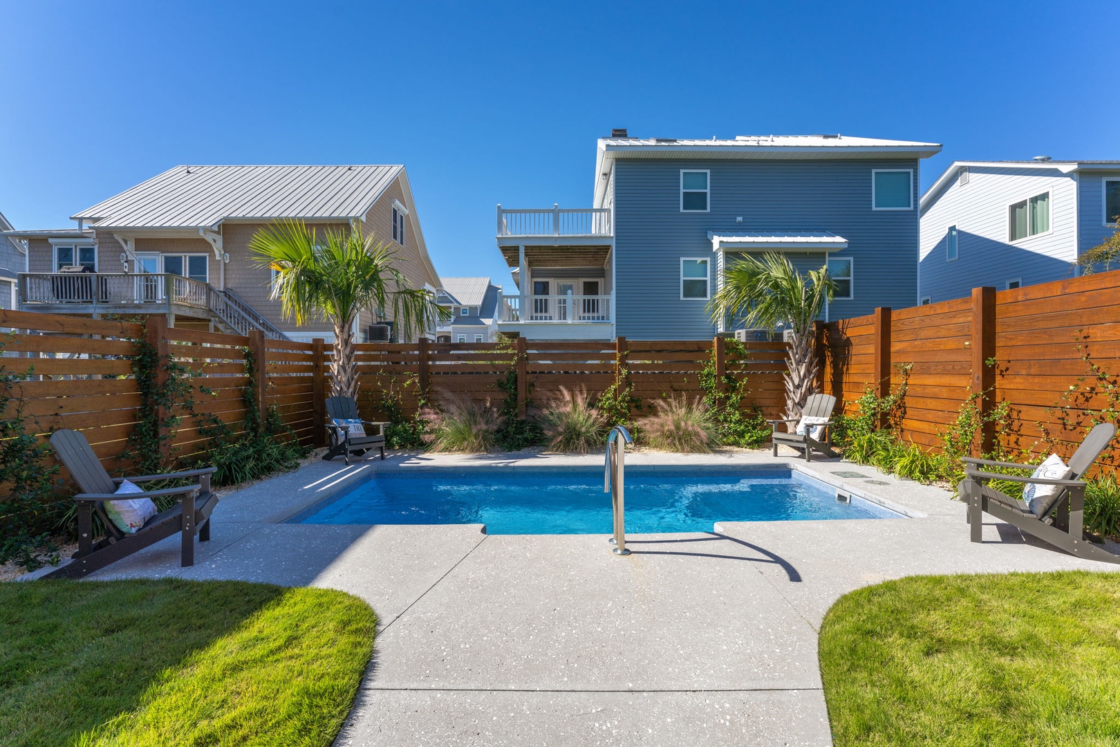 Take a refreshing dip in your private pool, surrounded by tropical palms and comfortable lounge chairs for ultimate relaxation.