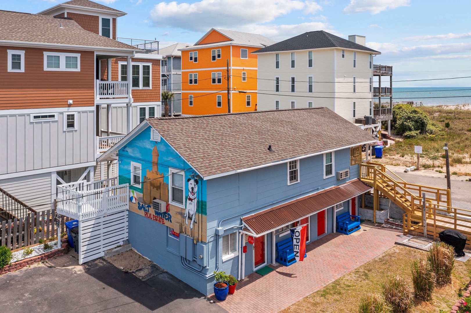 Colorful beachside buildings create a vibrant coastal community with easy beach access and charming neighborhood atmosphere.