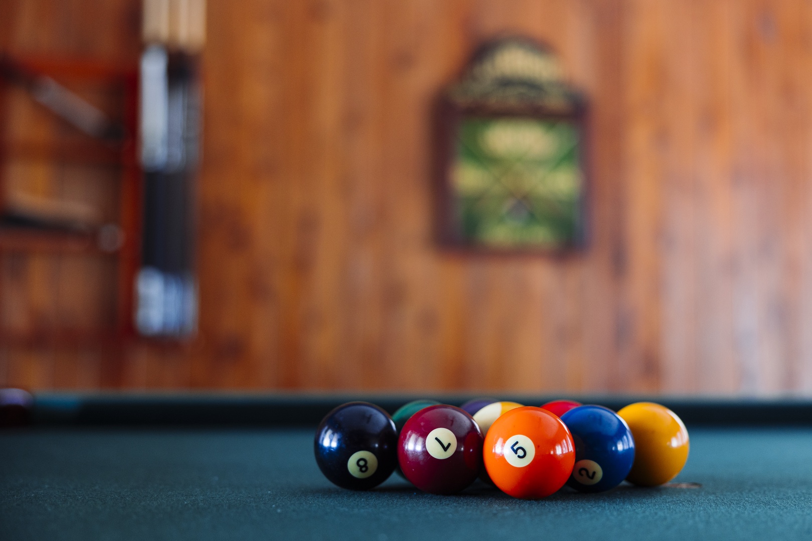 Challenge friends to a game on your private pool table, complete with colorful balls ready for action in this cozy game room.