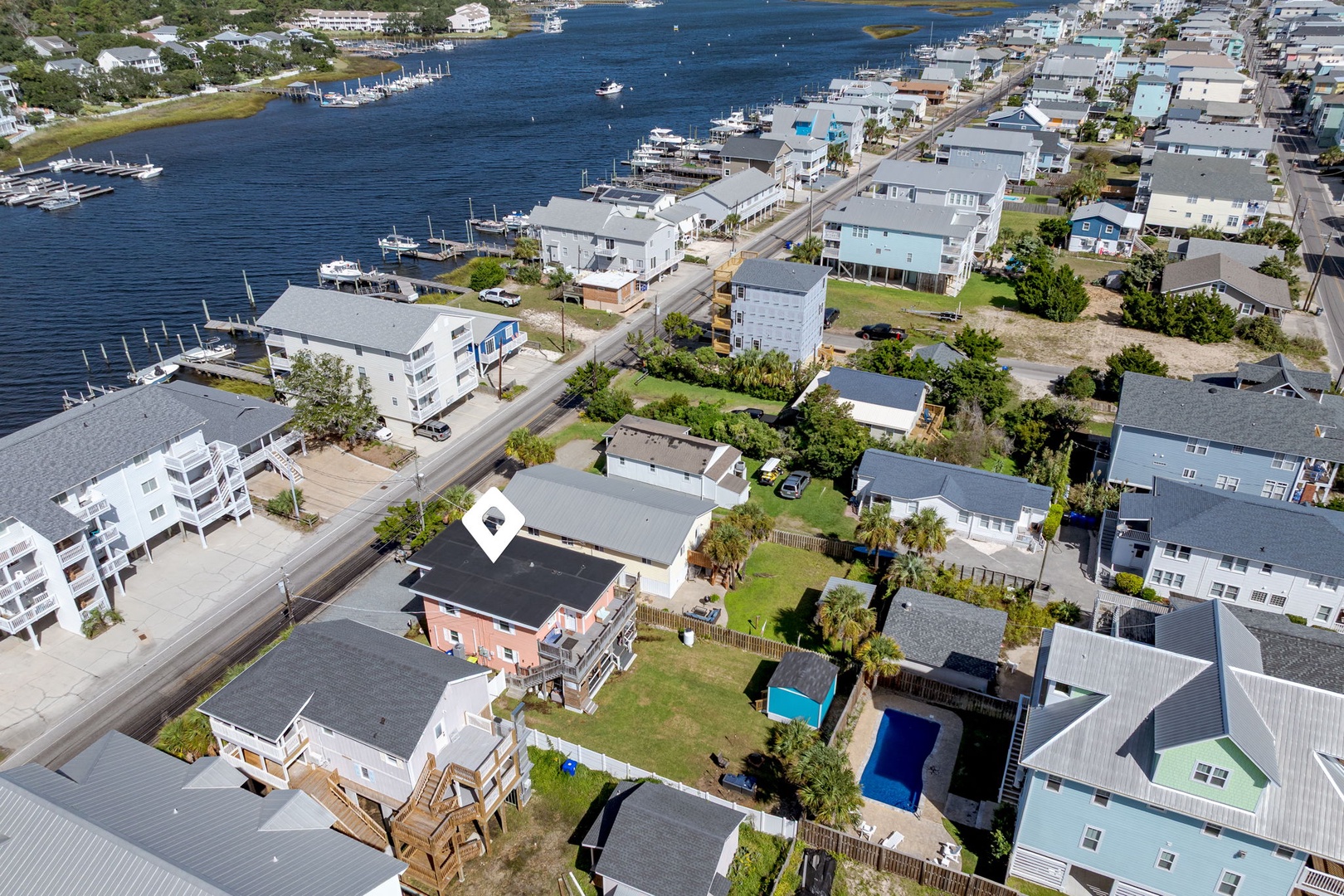 Coastal community overlooking scenic waterfront with marinas, boats, and charming neighborhood streets perfect for exploring nearby attractions.