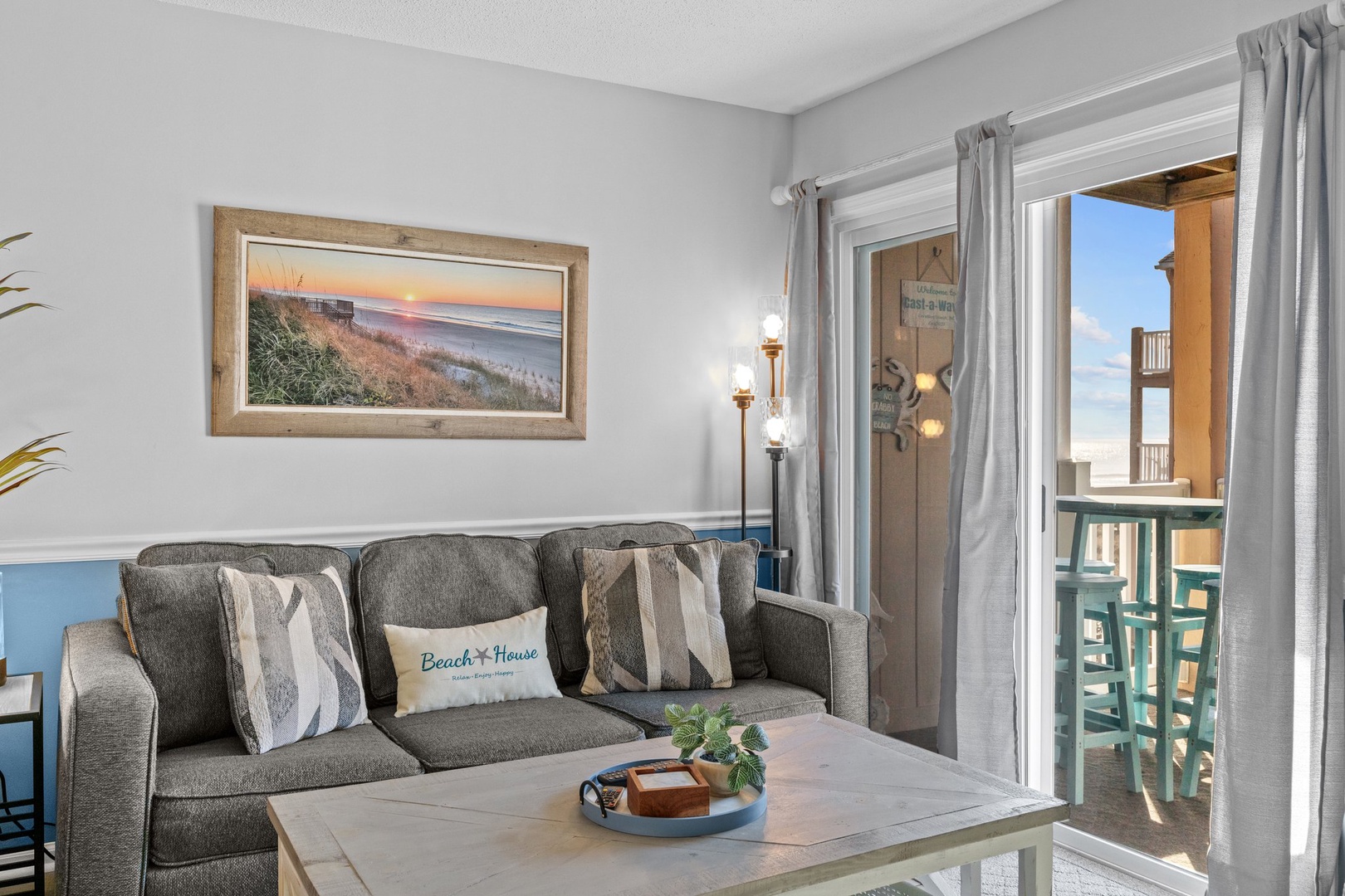 Sink into coastal comfort on this plush sofa while beach artwork sets your vacation mood perfectly.