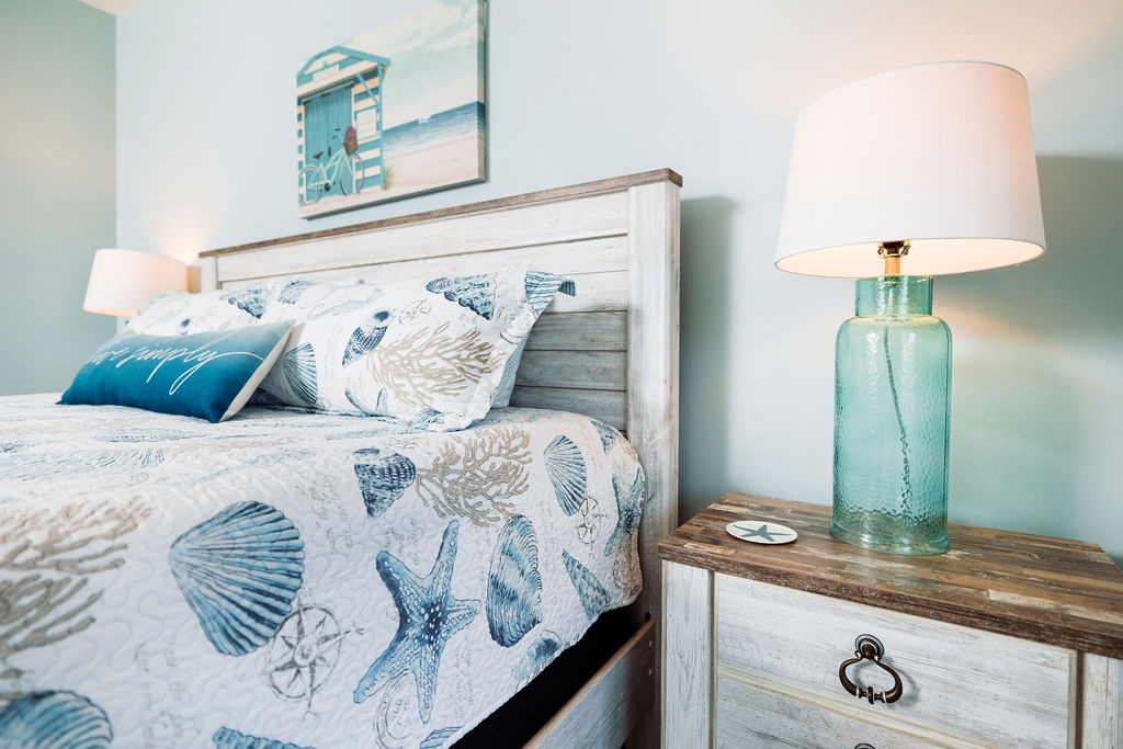 Drift off in this coastal bedroom where ocean blues meet crisp whites, creating your perfect seaside sanctuary.