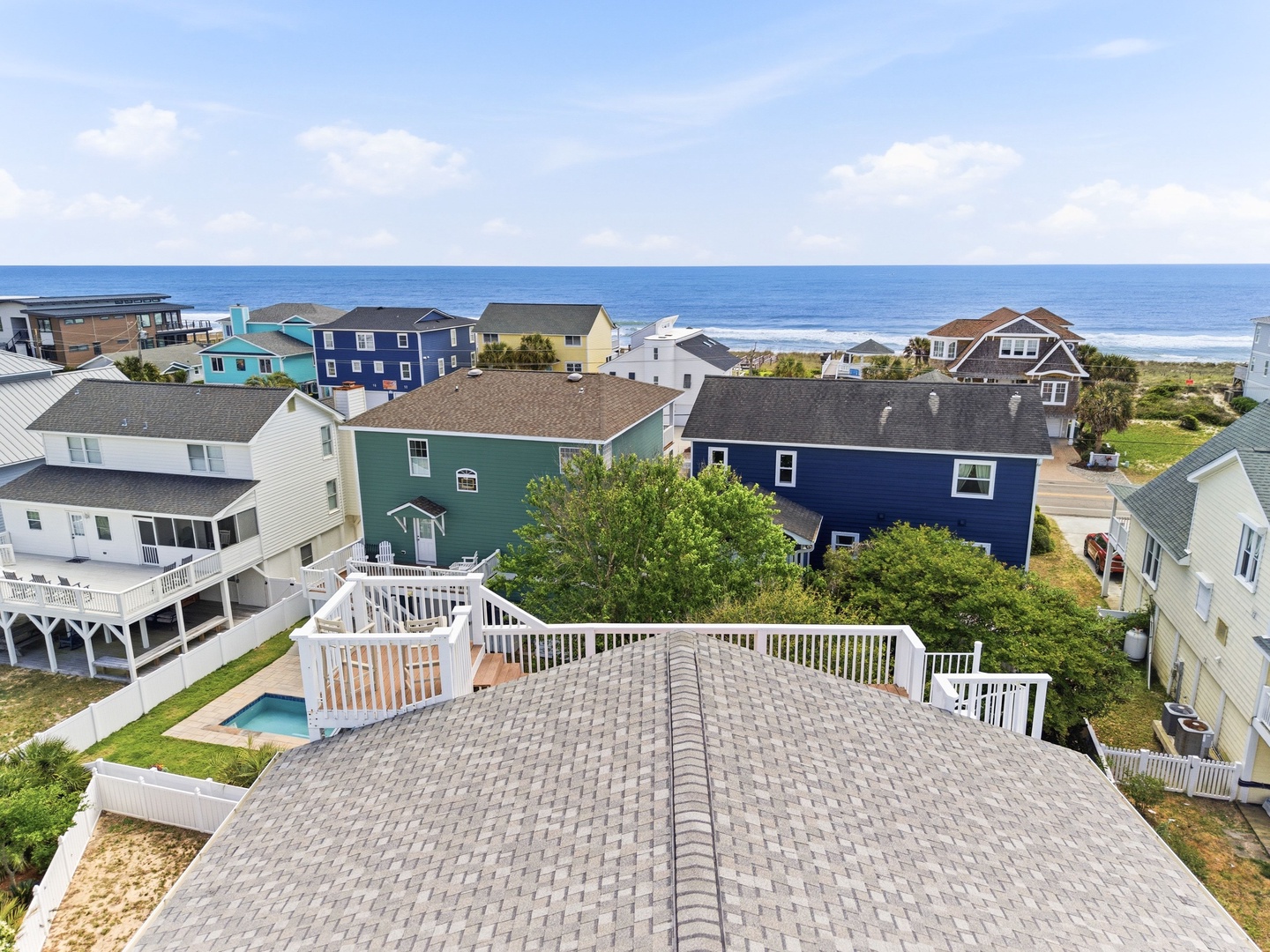 Coastal neighborhood featuring vacation homes with direct ocean access and scenic beachfront views. Property located among charming beach houses with rooftop deck overlooking the shore.
