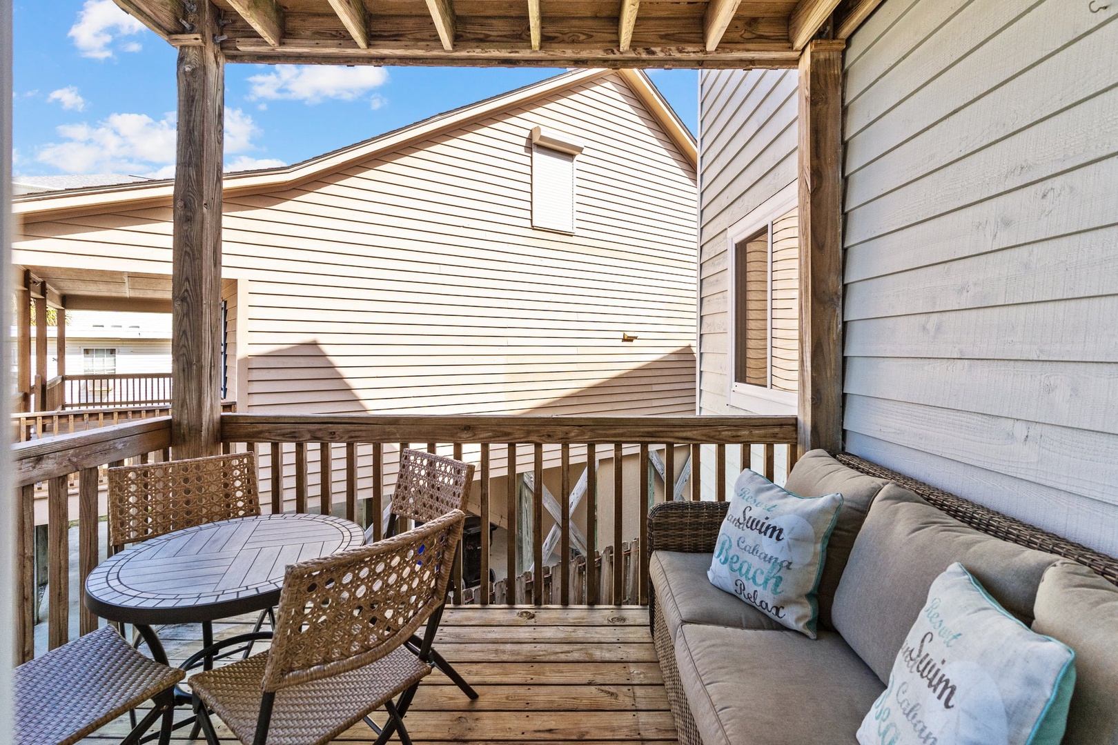 Relax on your private covered balcony with comfortable seating and dining space, perfect for morning coffee or evening unwind.