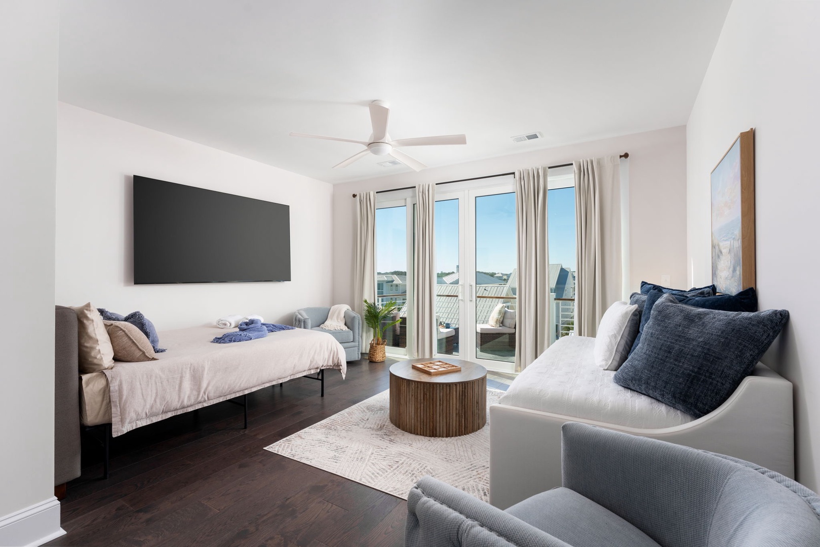 Relax in your bright, airy bedroom with comfortable seating area, flat-screen TV, and peaceful balcony access for morning coffee.