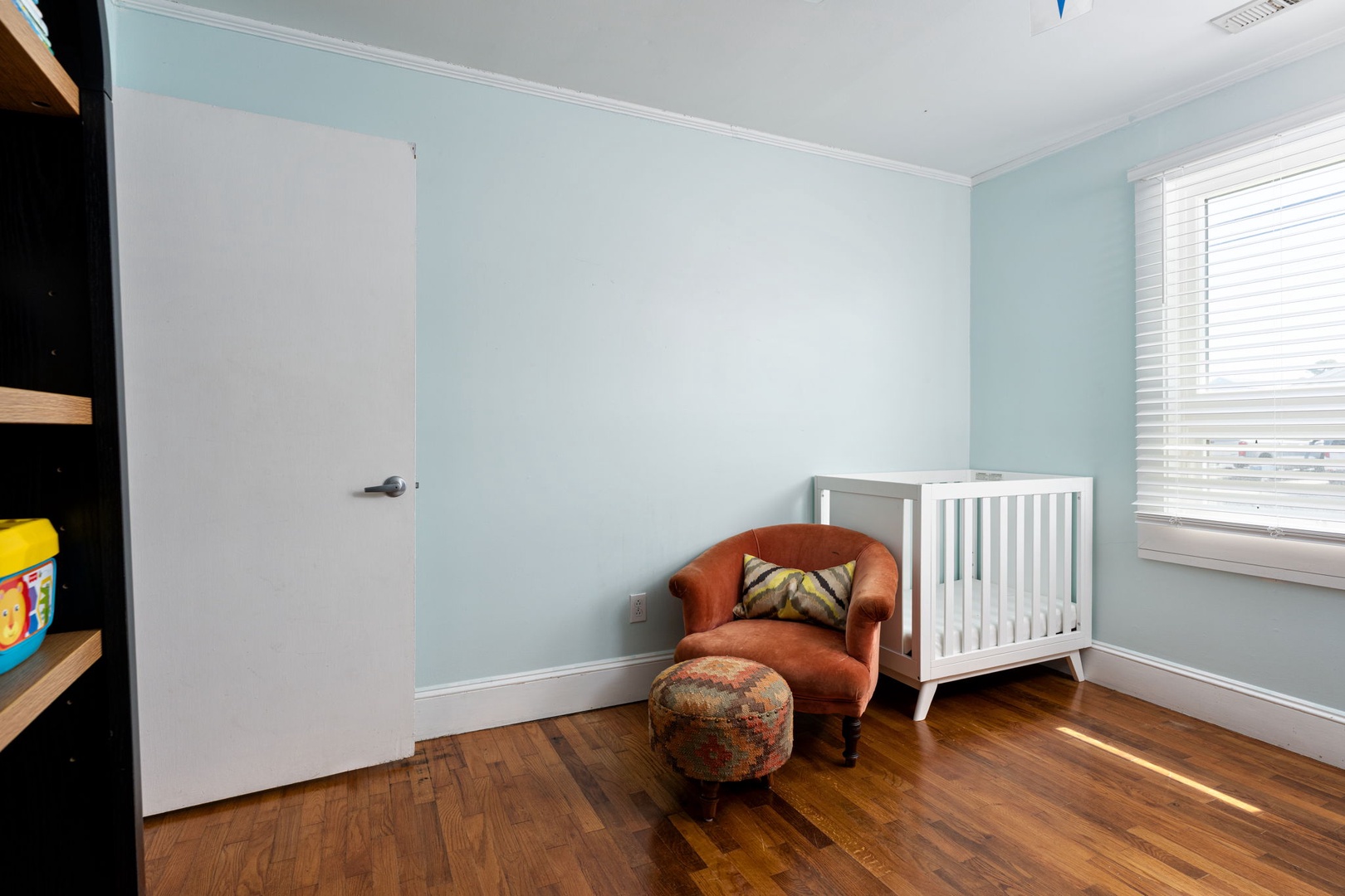 Your little one will sleep peacefully in this serene nursery, complete with a cozy reading chair where you can share bedtime stories together.