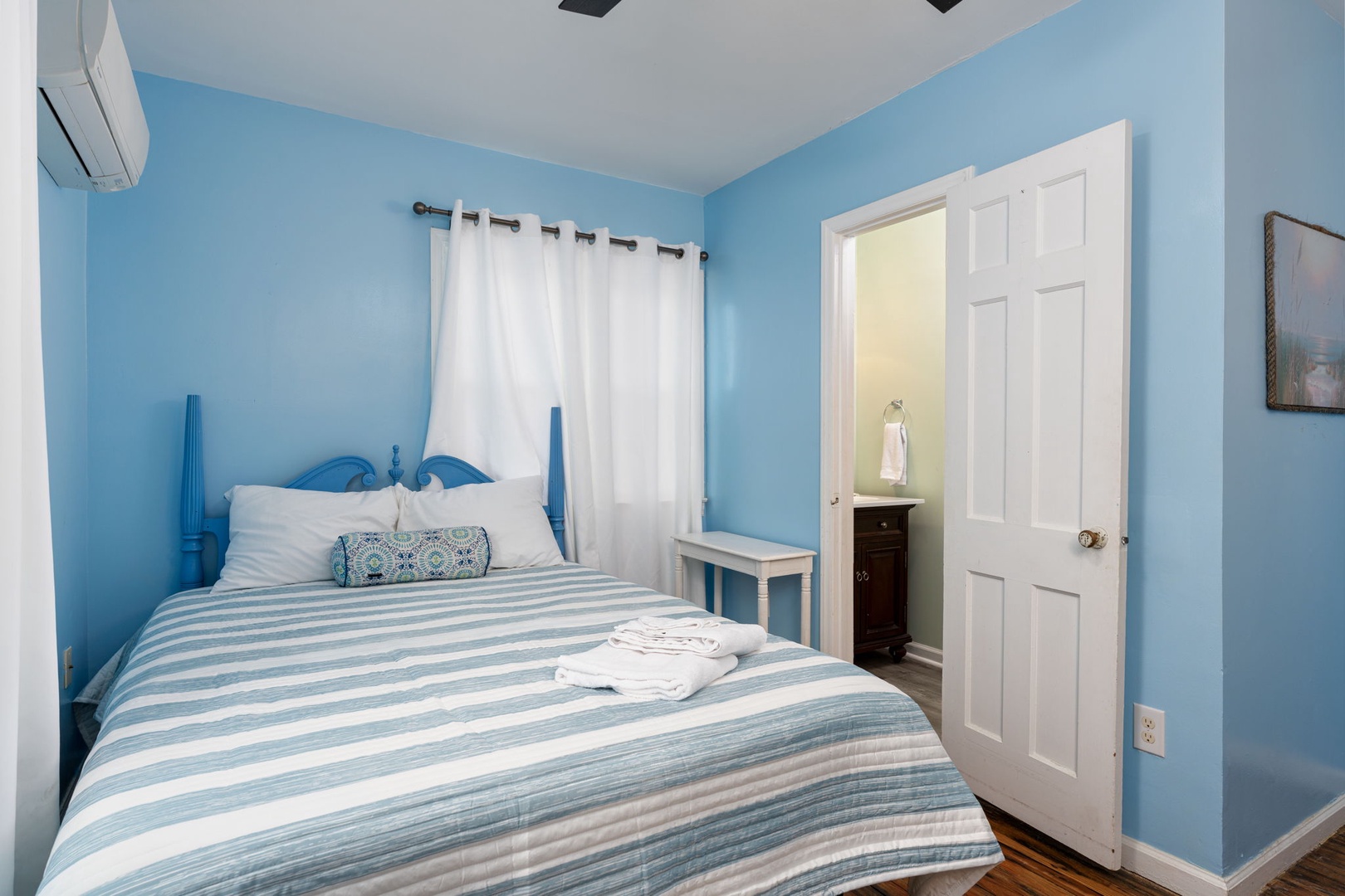 Slip into crisp linens and drift off beneath calming blue walls. Your private bedroom features cooling AC, fresh towels waiting on the bed, and a peaceful space to recharge after exploring.