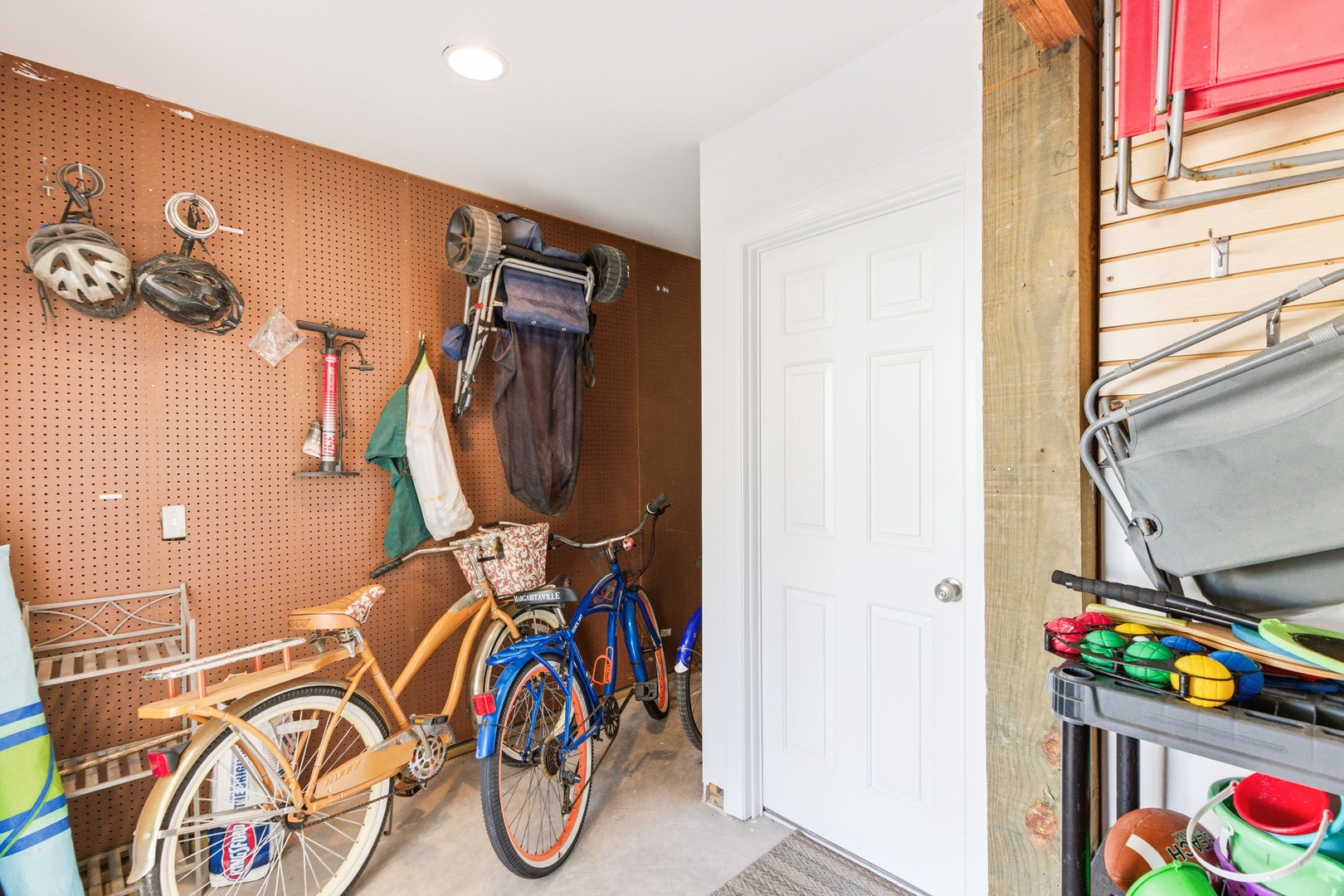 Your gear stays organized in this dedicated storage space, with pegboard walls for easy access and plenty of room for beach bikes and outdoor essentials.