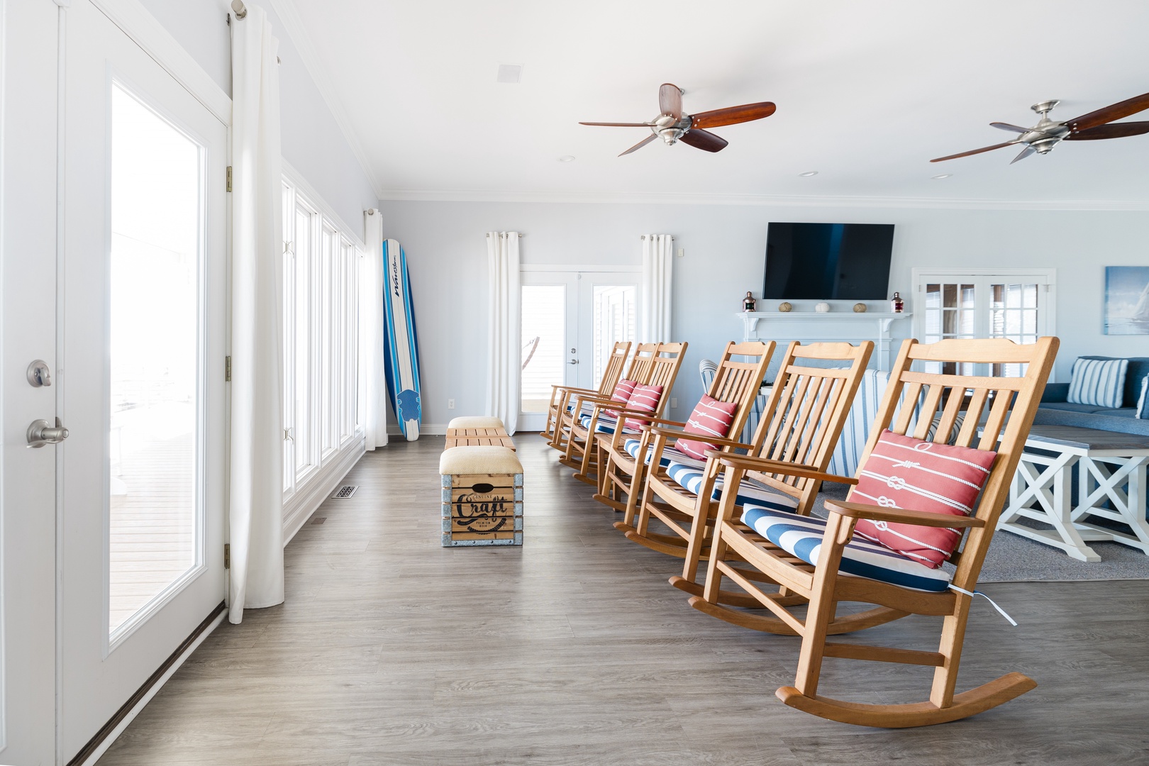 Unwind in your bright, airy living space with cozy rocking chairs perfect for morning coffee or evening relaxation together.