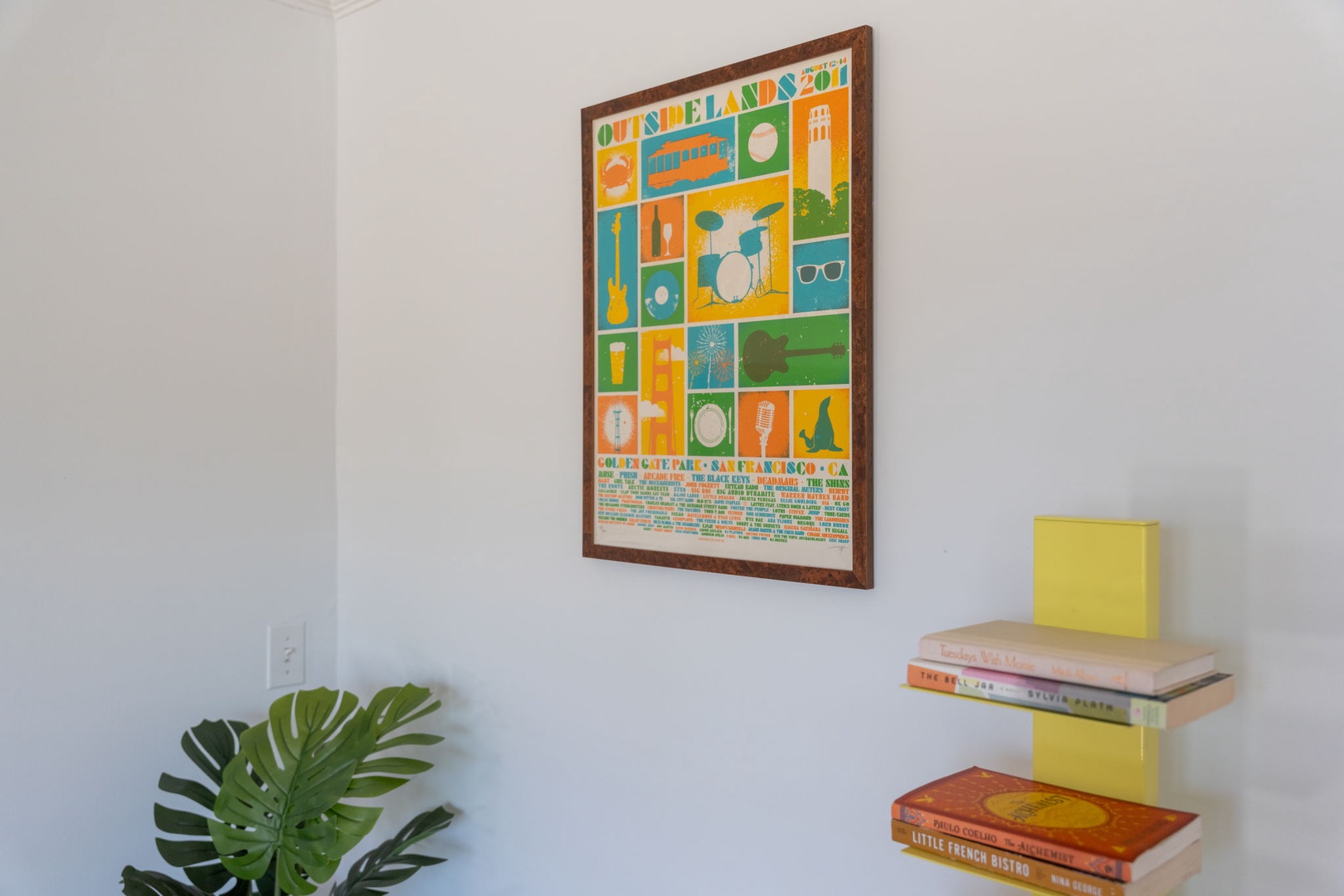 Relax with your favorite book from the floating shelf library, surrounded by colorful artwork and lush greenery.