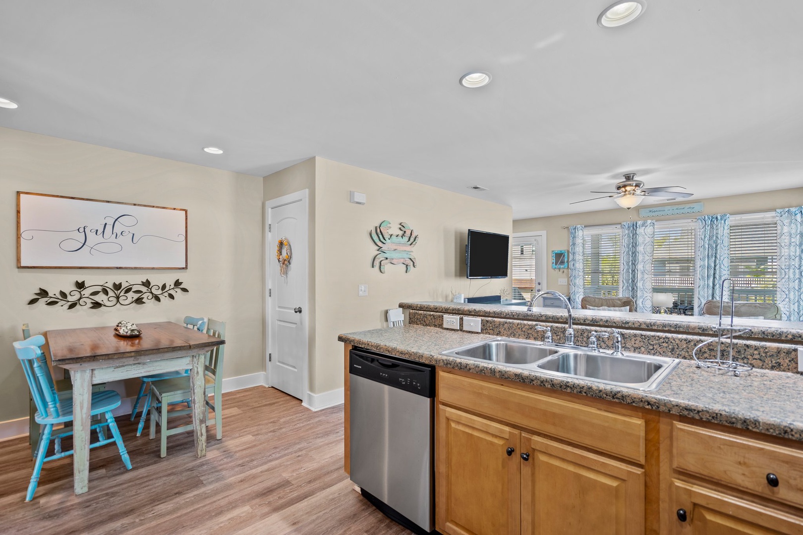 Your open kitchen flows seamlessly into a charming dining nook where you'll love sharing meals at the rustic wood table.