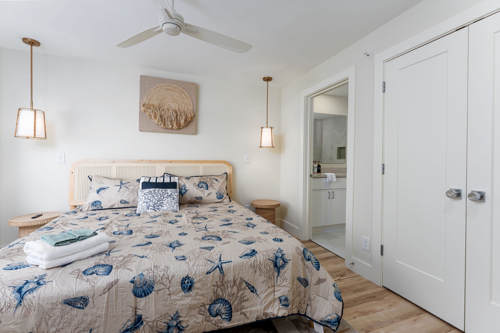 Drift off to sleep in your serene coastal bedroom, where ocean-themed linens and warm wood touches create a peaceful seaside retreat.
