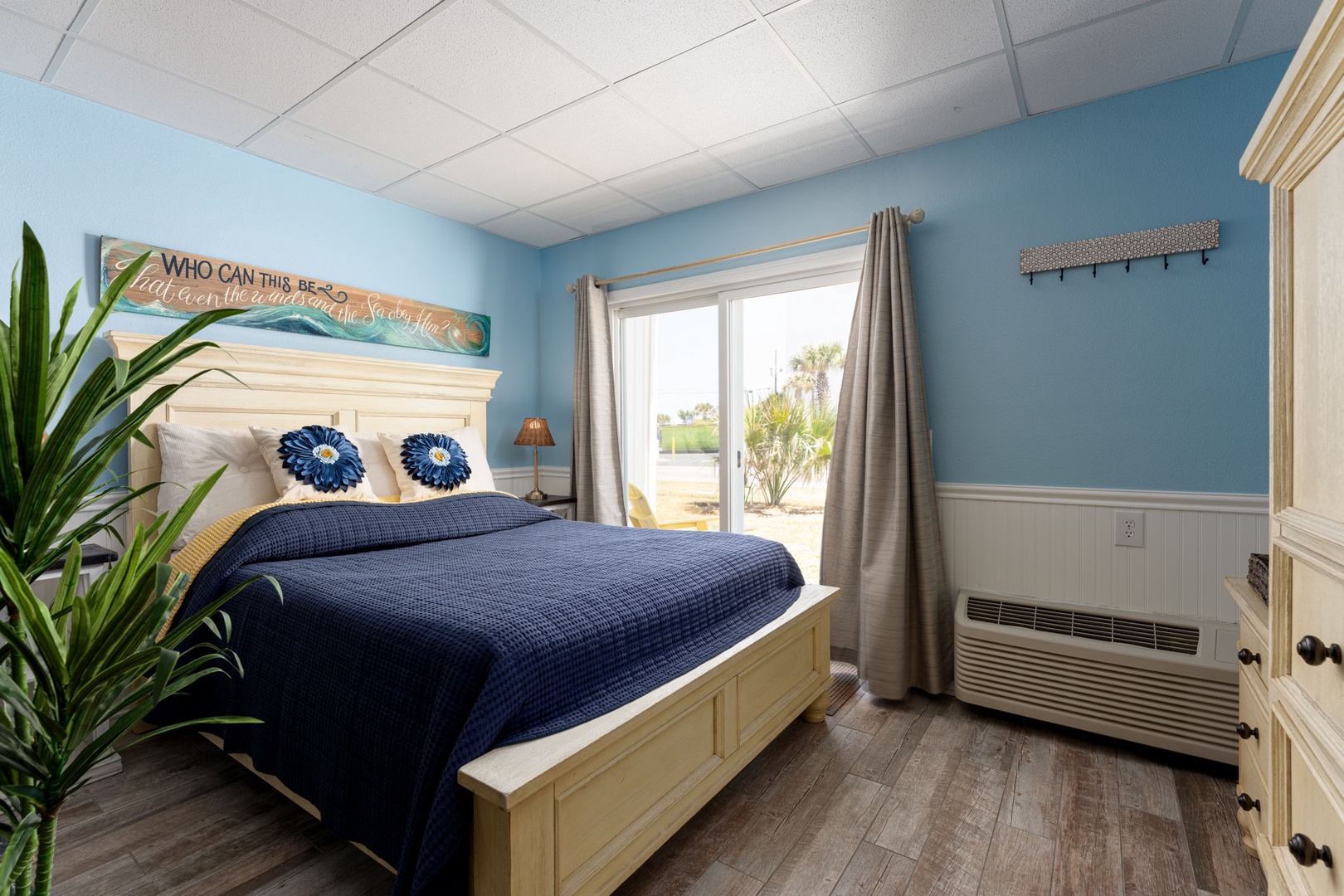 Your coastal-themed bedroom features crisp navy bedding and calming blue walls, creating the perfect seaside retreat for restful nights.