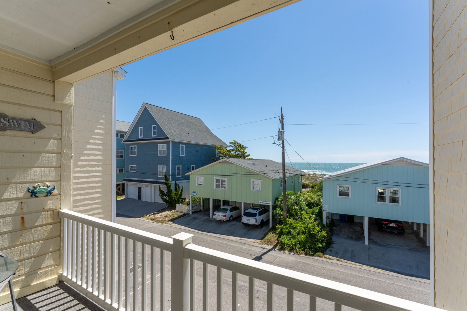 Charming coastal neighborhood positioned near the beach, featuring residential homes and ocean views just beyond the property.