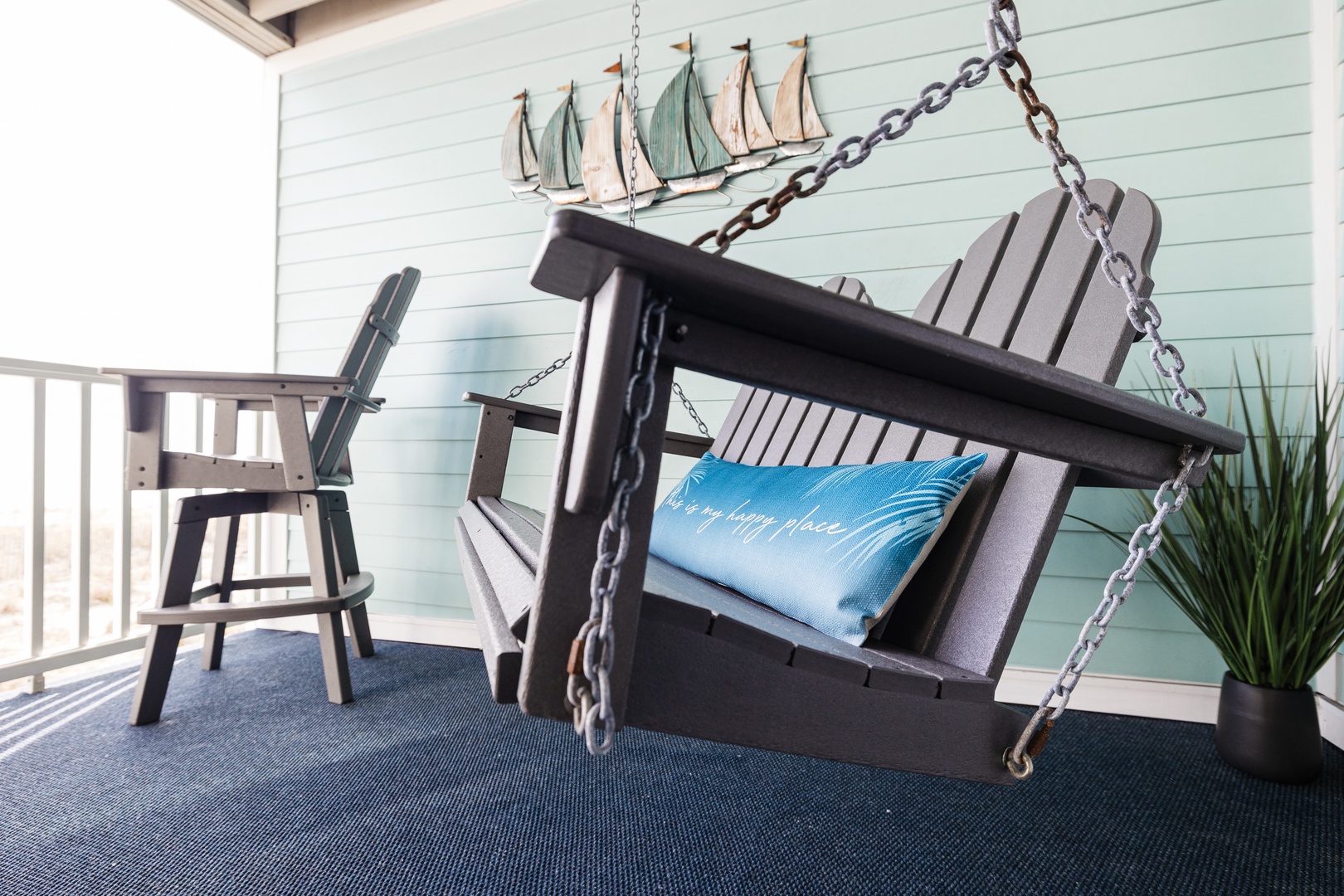 Swing gently into vacation mode on your private porch swing, where coastal charm meets comfort with nautical touches and peaceful vibes.