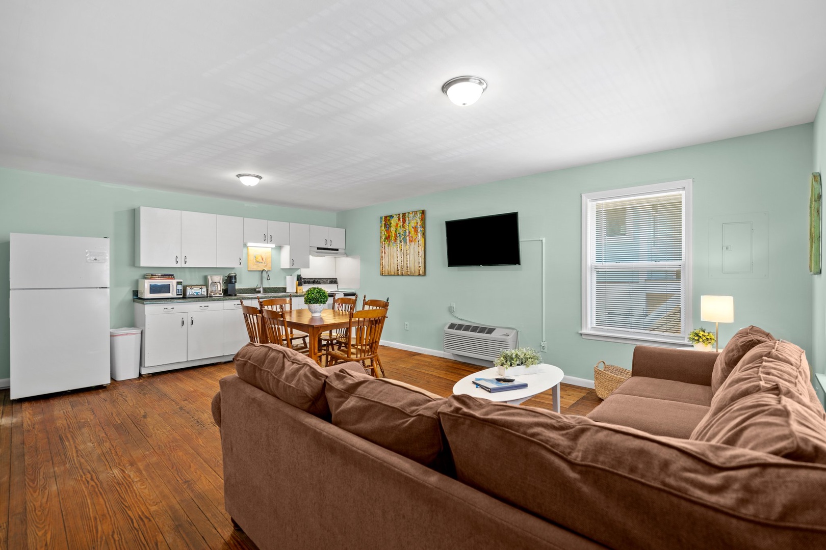 Relax in your open-concept space with plush seating, full kitchen, and warm wood floors perfect for unwinding after exploring.