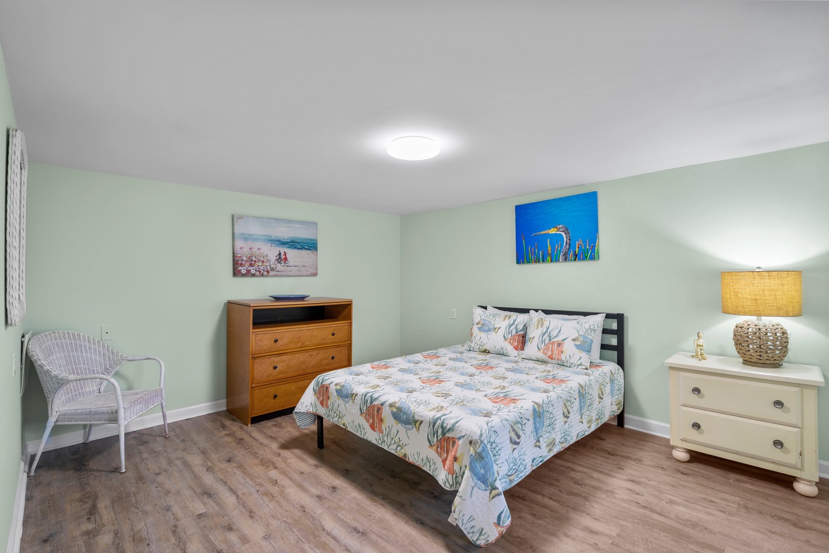 Sink into this peaceful bedroom with coastal artwork and soft lighting creating your perfect retreat after busy days exploring.