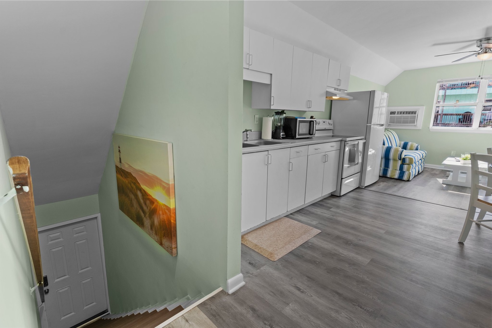 Your fully equipped kitchen features modern appliances and opens to a bright dining area, perfect for home-cooked meals during your stay.
