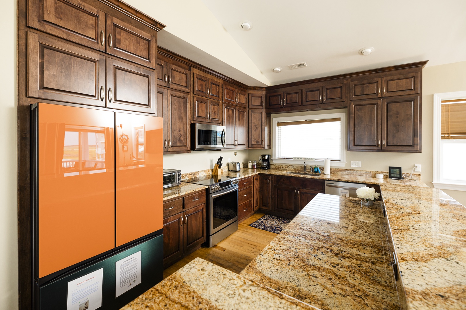 Step into your gourmet kitchen where rich walnut cabinets and gleaming granite counters create the perfect space for culinary adventures.