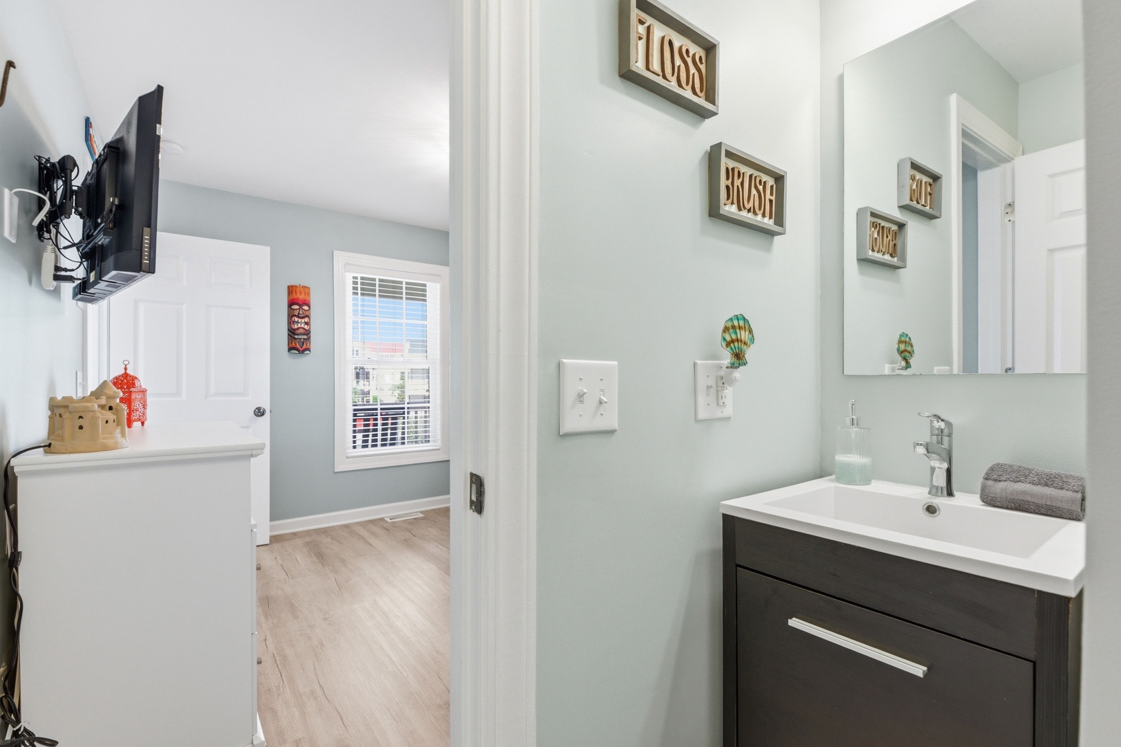 Freshen up in your spa-inspired bathroom with coastal decor, a modern vanity, and thoughtful touches that make every moment feel like a retreat.