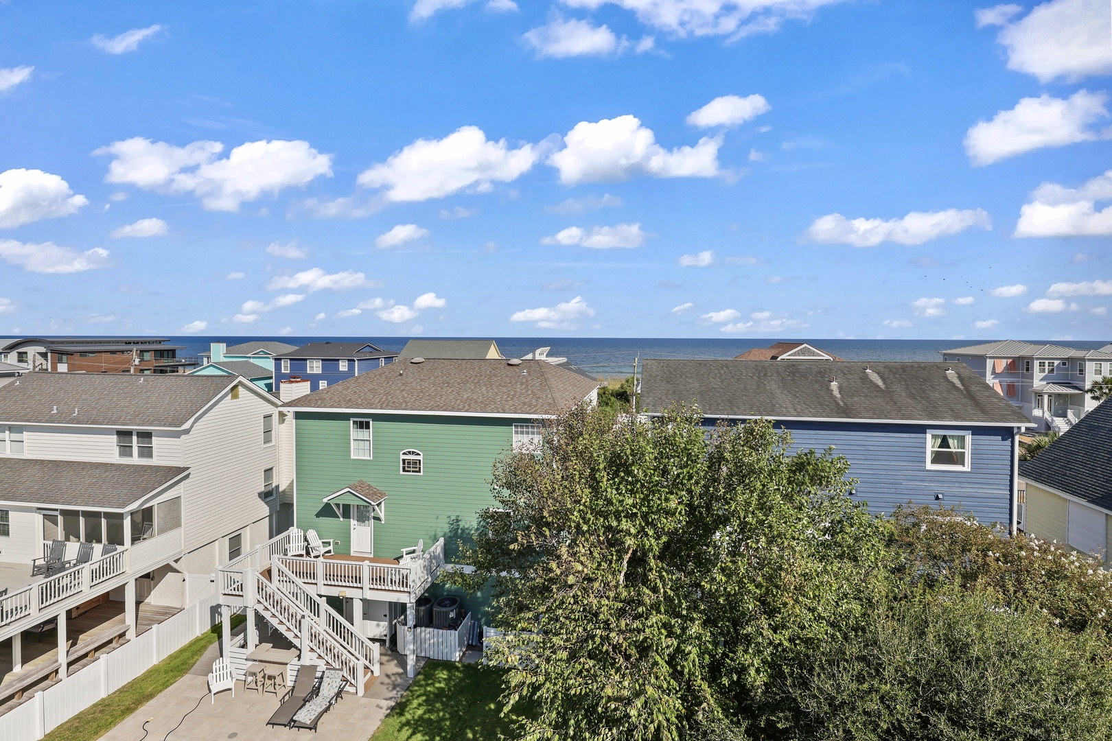 Coastal neighborhood with residential homes and oceanfront views, featuring nearby beaches and water access for guests seeking a seaside retreat.