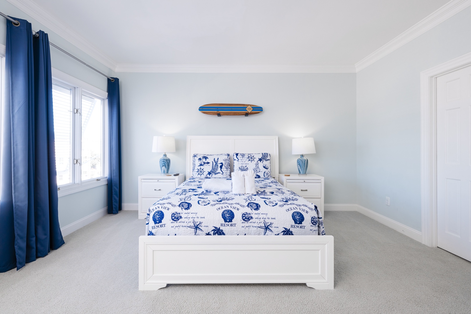 Rest peacefully in your coastal-themed bedroom, where nautical blue accents and crisp white furnishings create a serene seaside escape.
